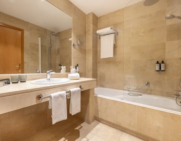 a bathroom with a shower and sink