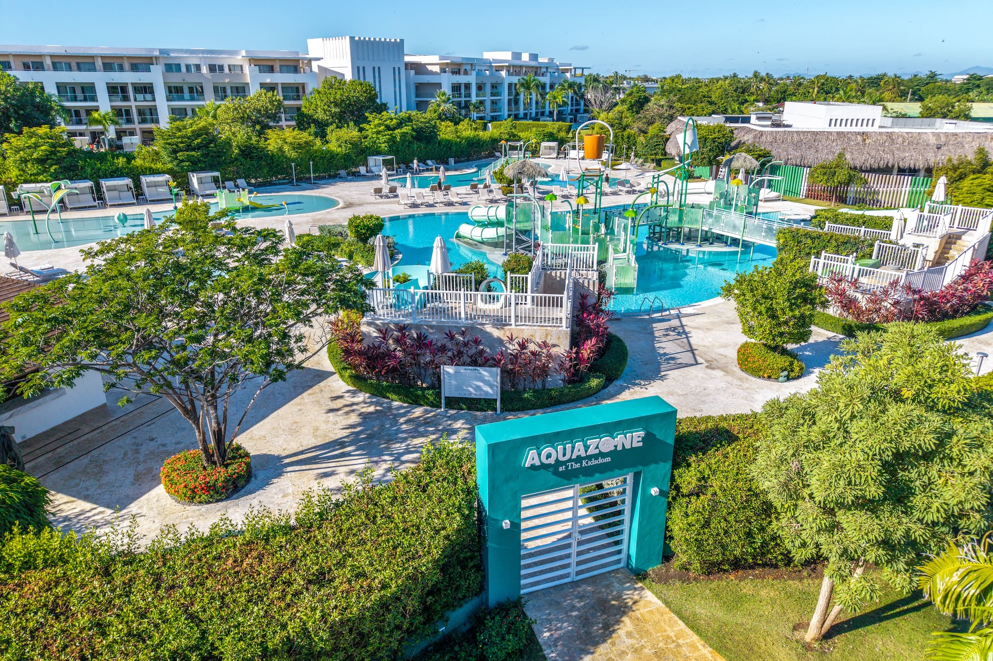 AquaZone tropical resort water park with pools, slides, and hotels.