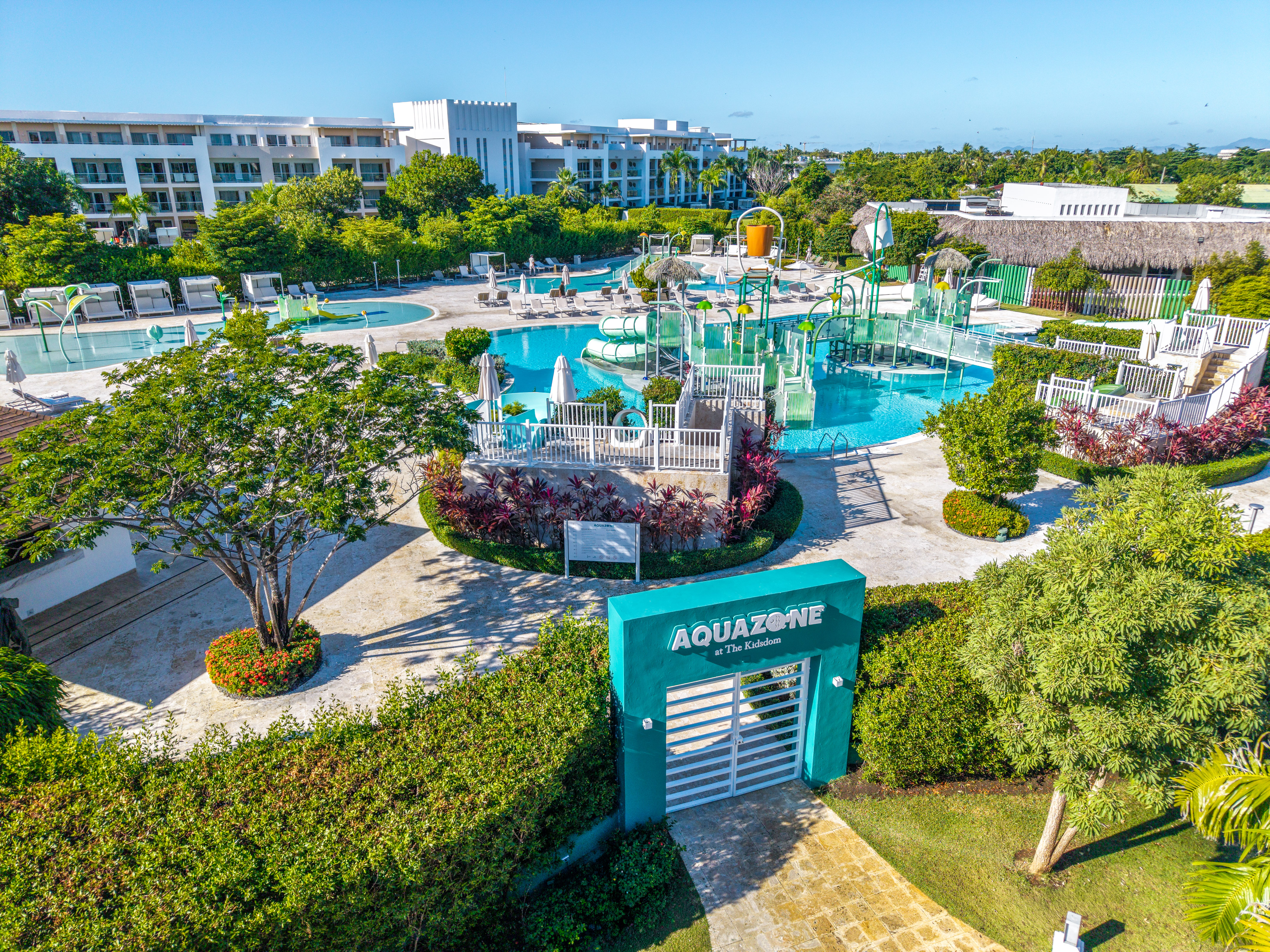 AquaZone tropical resort water park with pools, slides, and hotels.