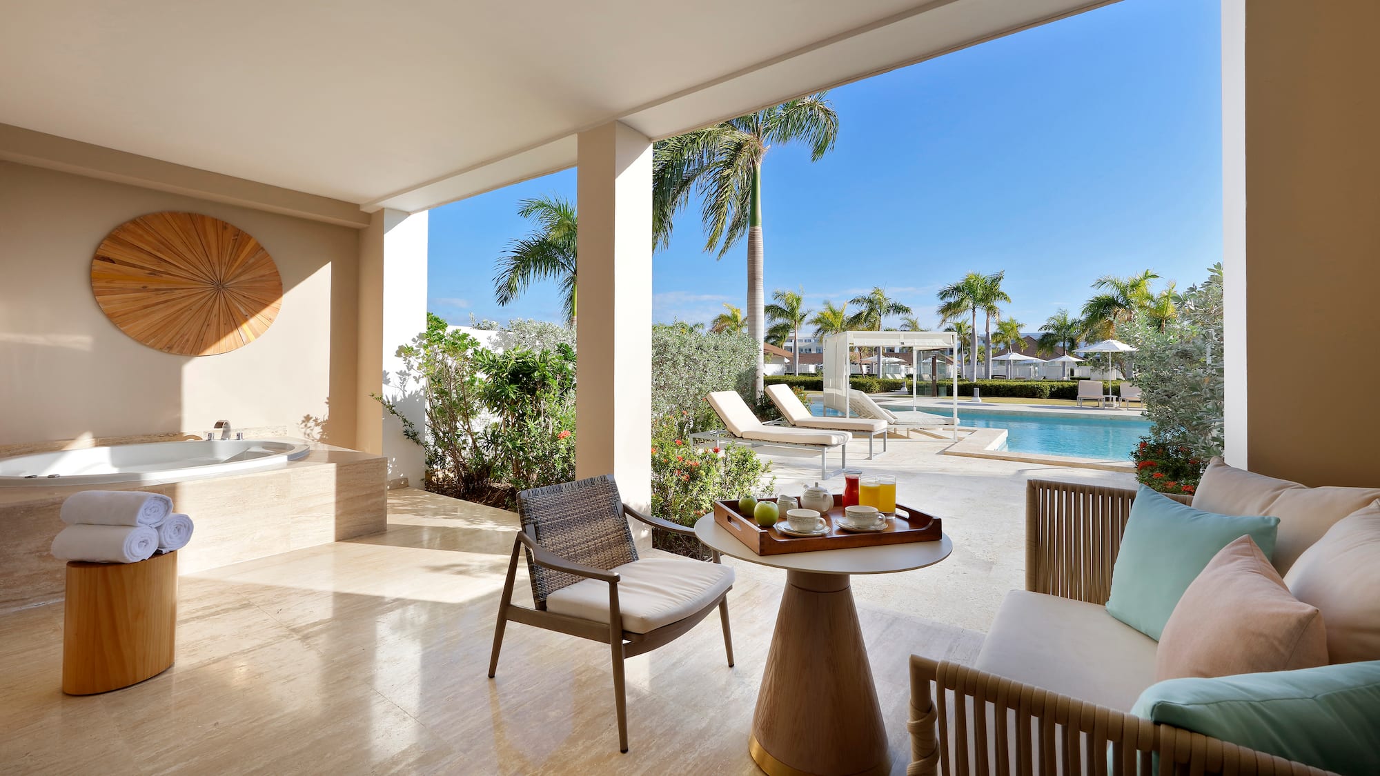 a patio with a hot tub and a table