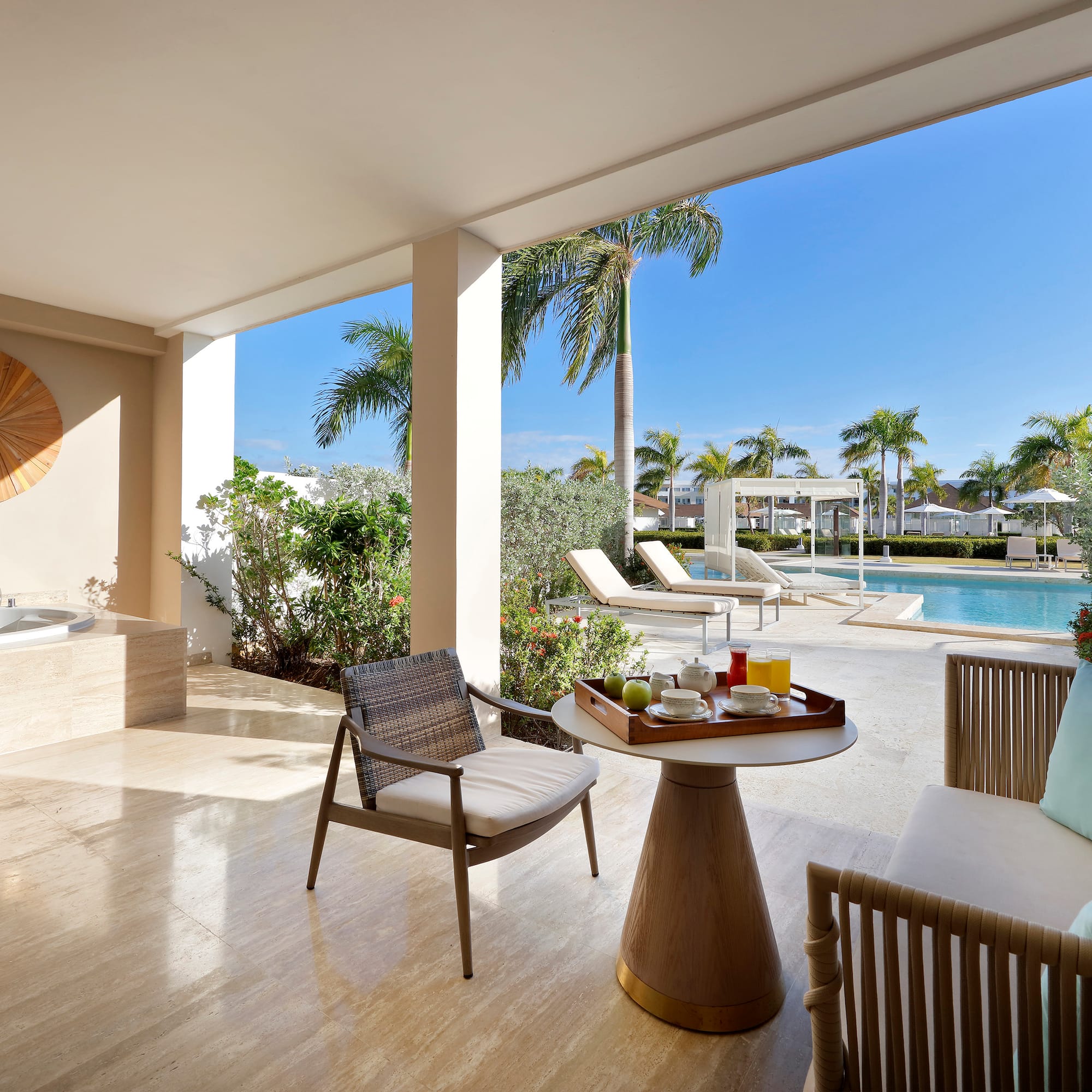 a patio with a hot tub and a table