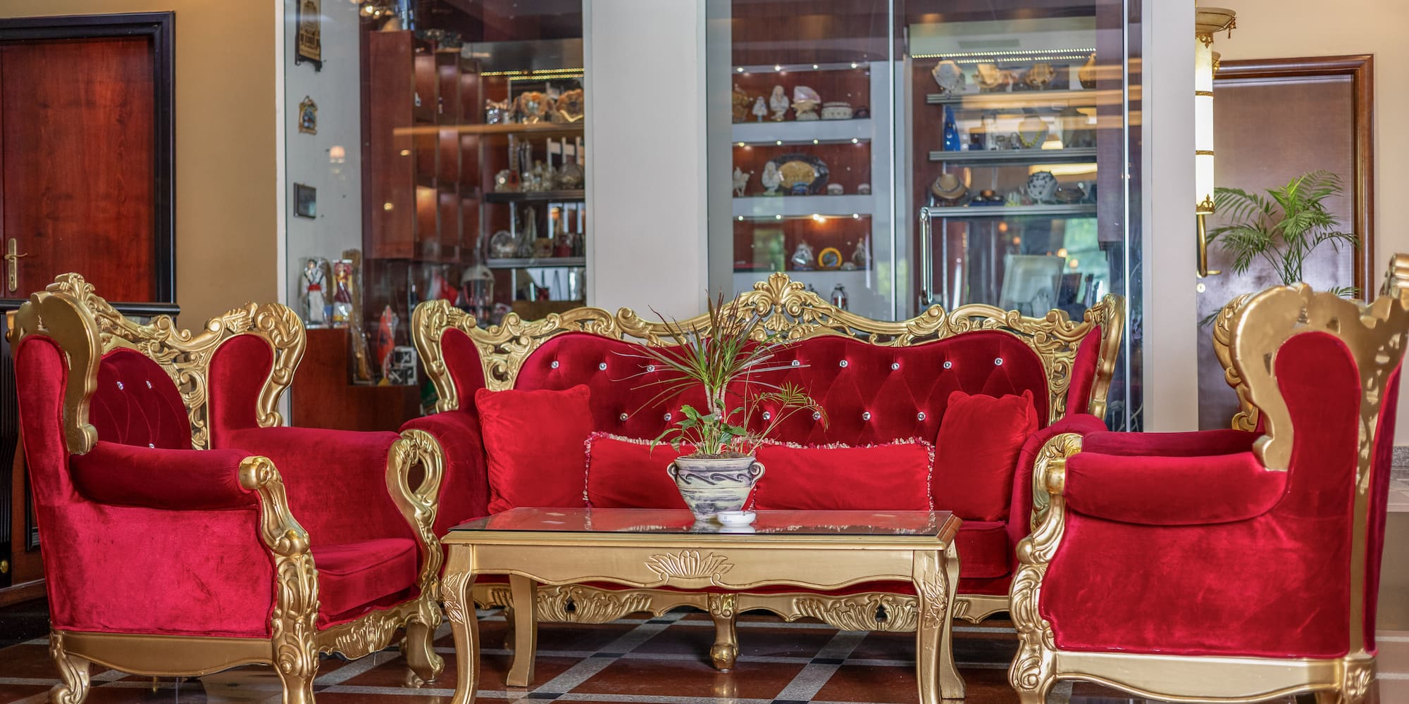 a room with red couches and a table