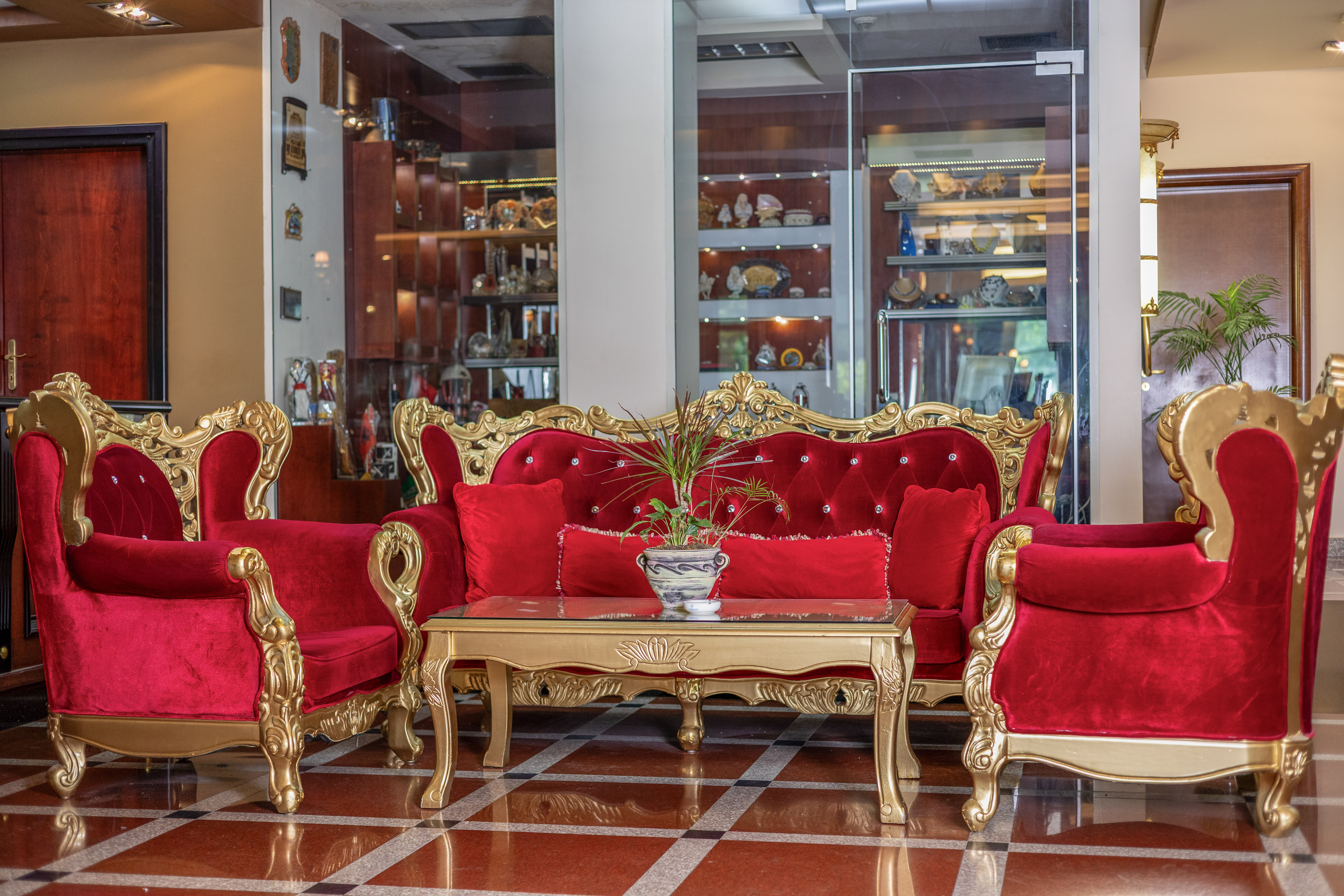 a room with red couches and a table