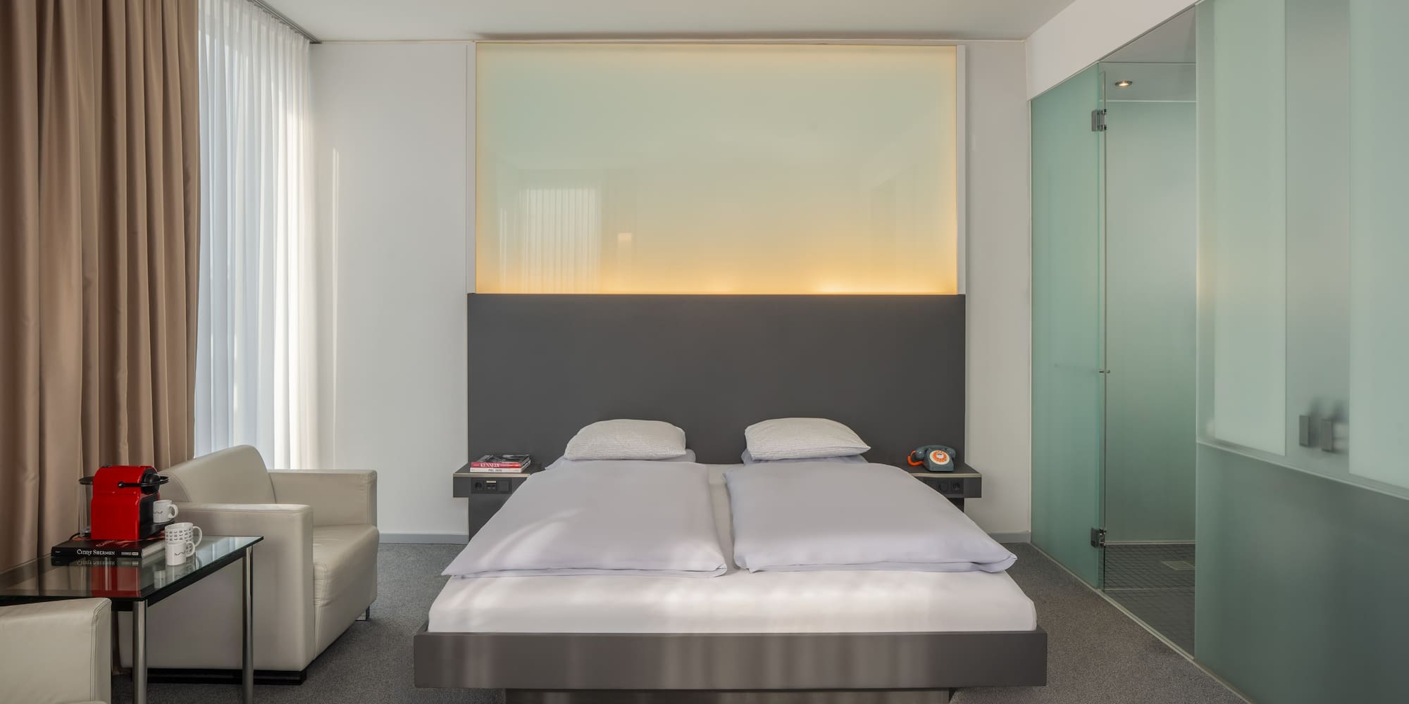 a bedroom with a bed and a glass shower