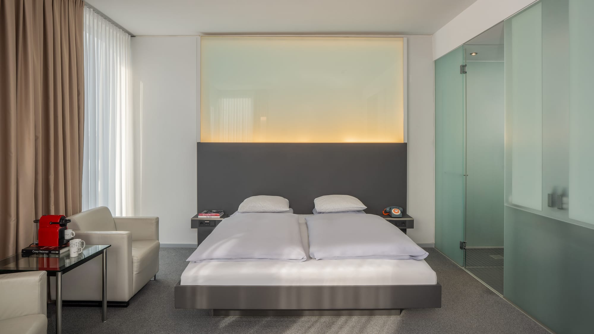 a bedroom with a bed and a glass shower