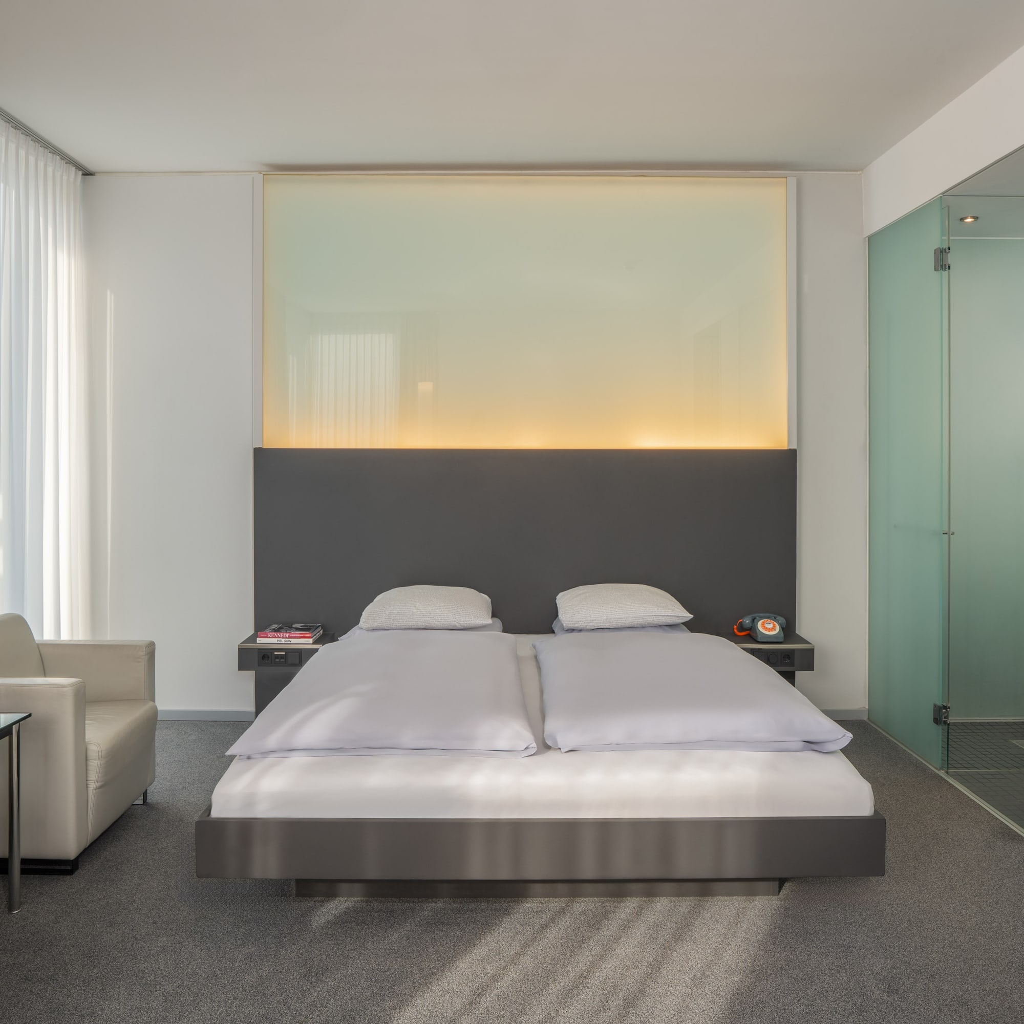 a bedroom with a bed and a glass shower