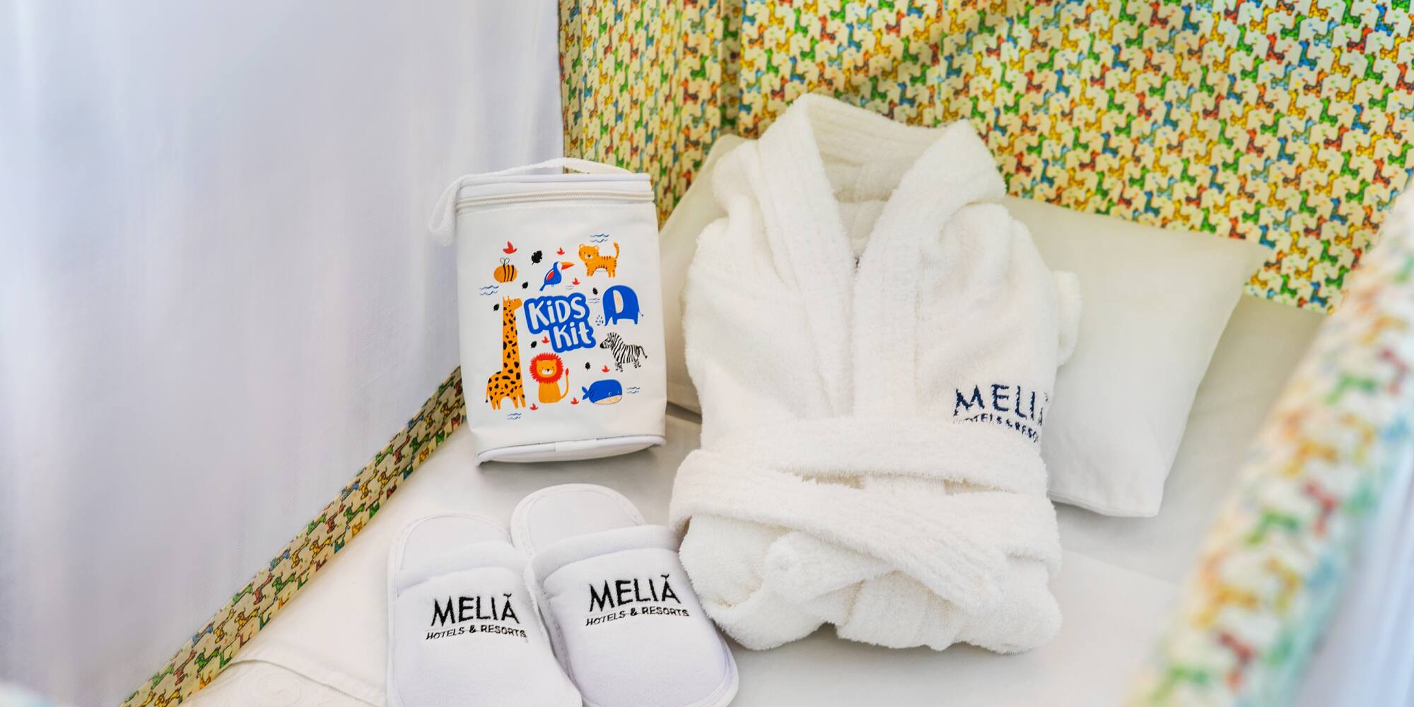 a white robe and slippers in a crib