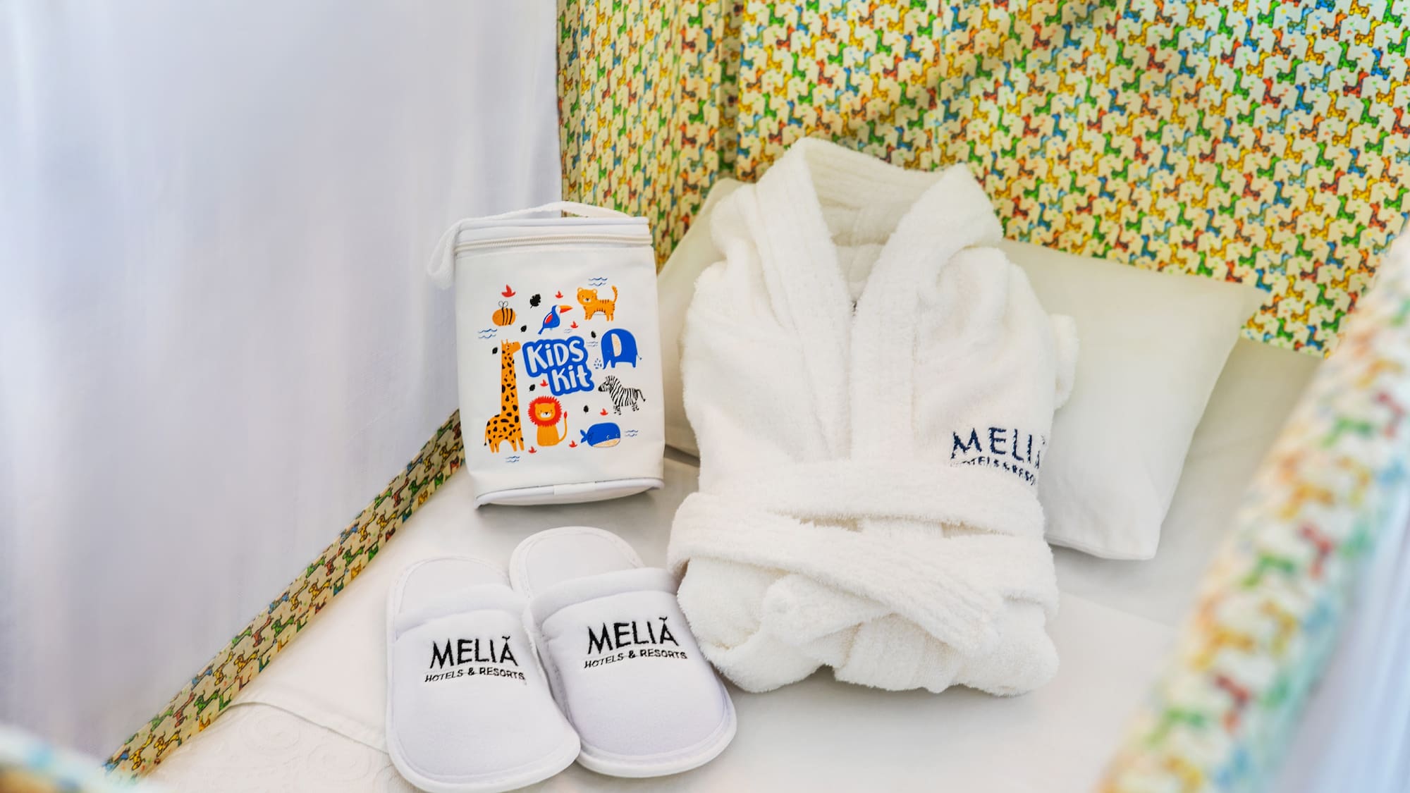 a white robe and slippers in a crib