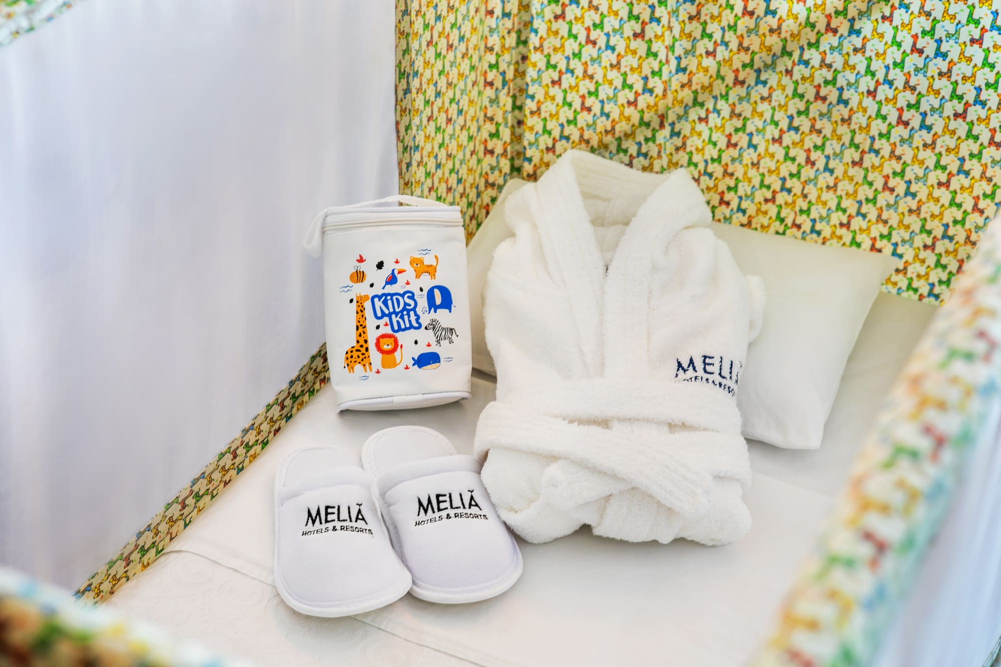 a white robe and slippers in a crib