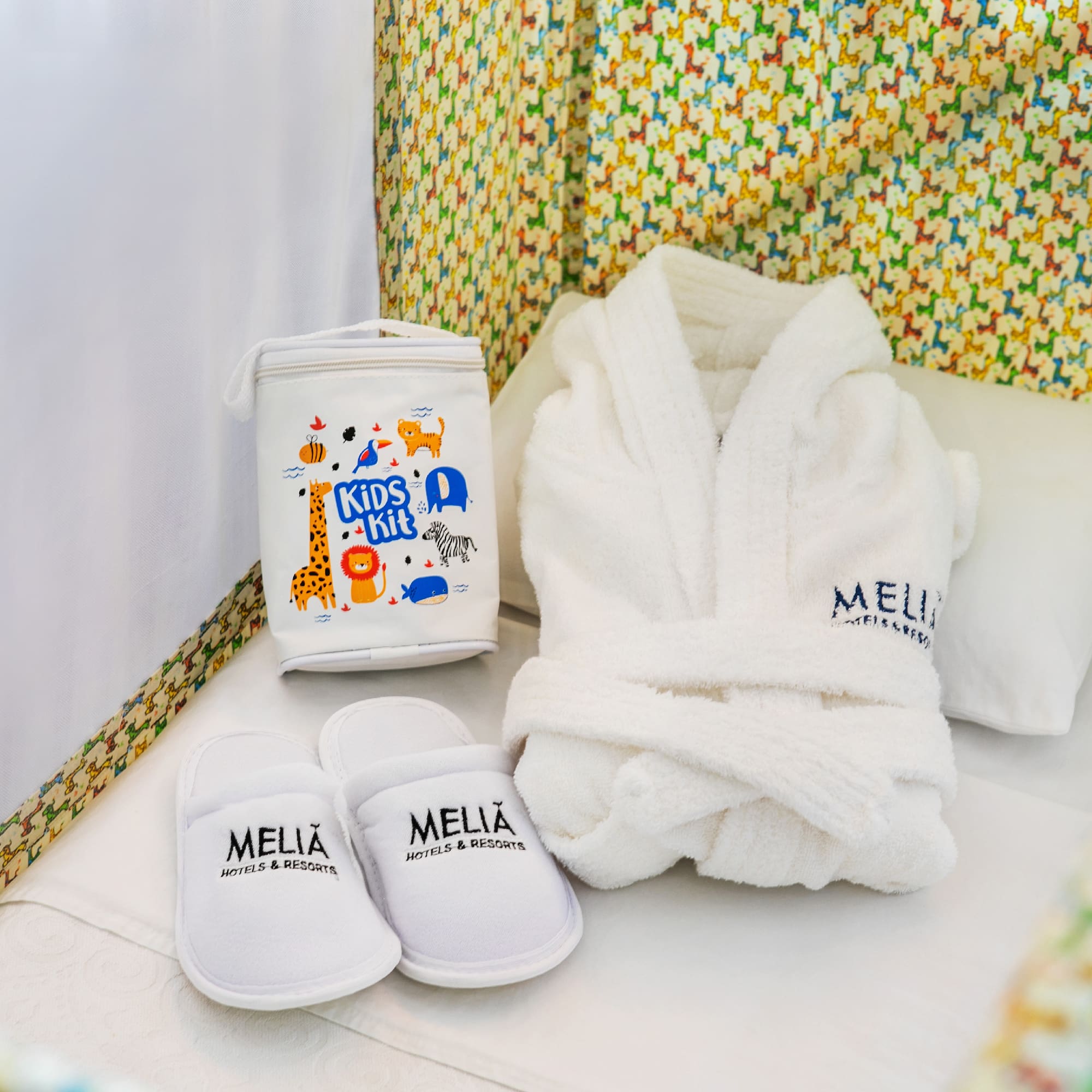 a white robe and slippers in a crib