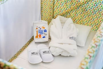 a white robe and slippers in a crib