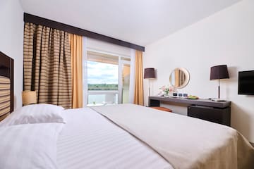 a bed with a mirror and a table with a window