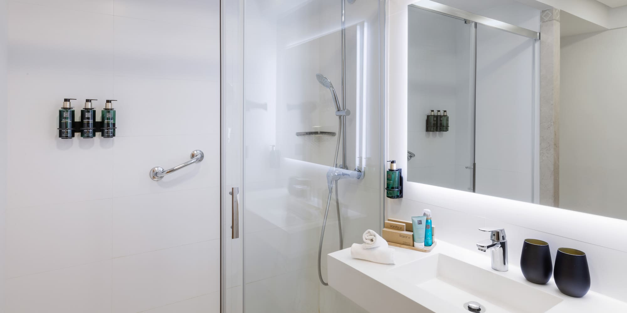a bathroom with a glass shower door