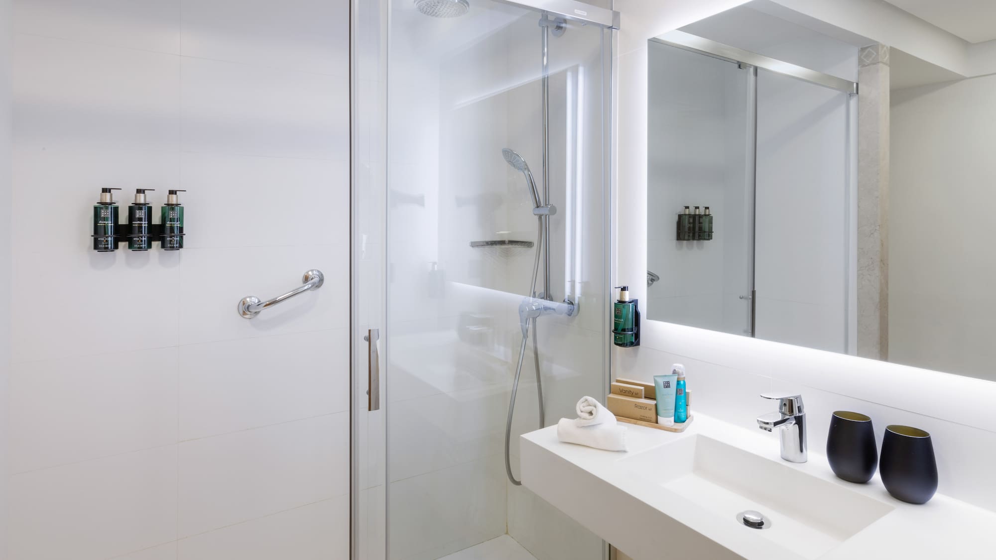 a bathroom with a glass shower door