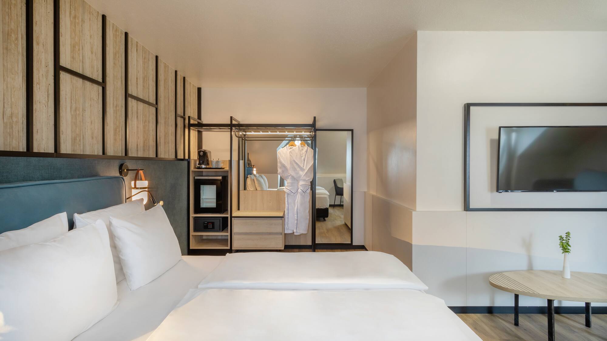 a room with a bed and a mirror