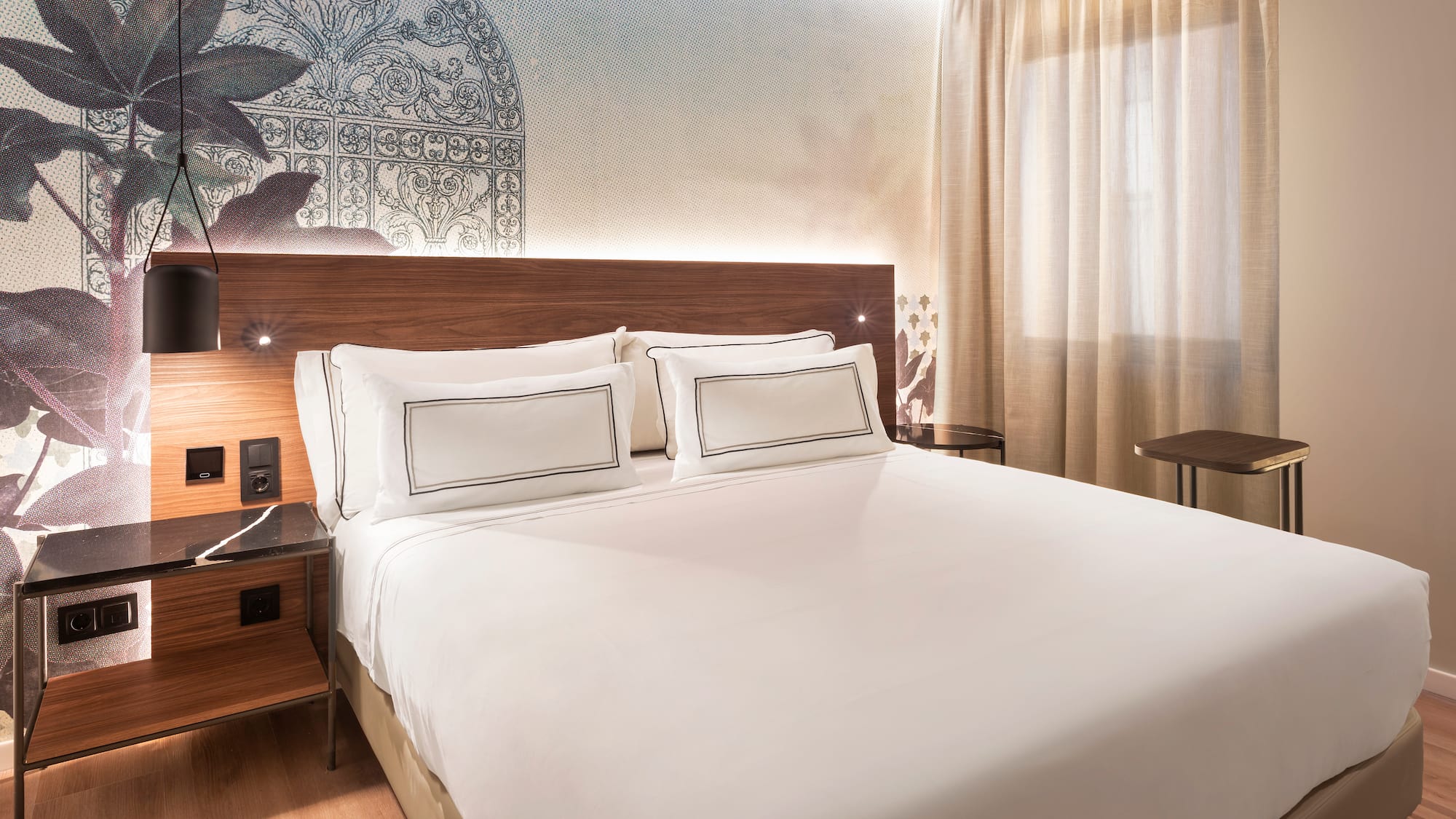 a bed with white sheets and a wood headboard