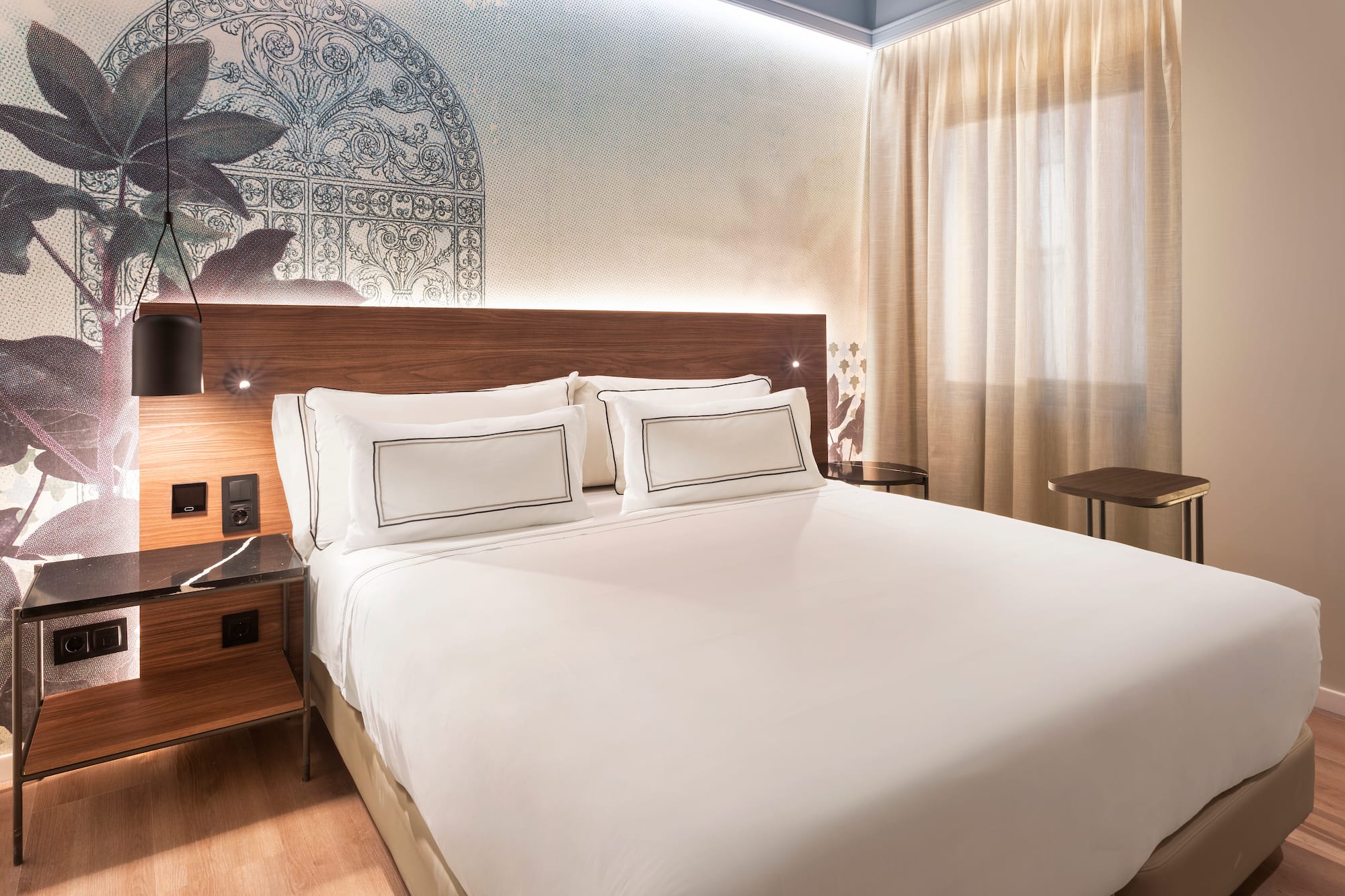 a bed with white sheets and a wood headboard