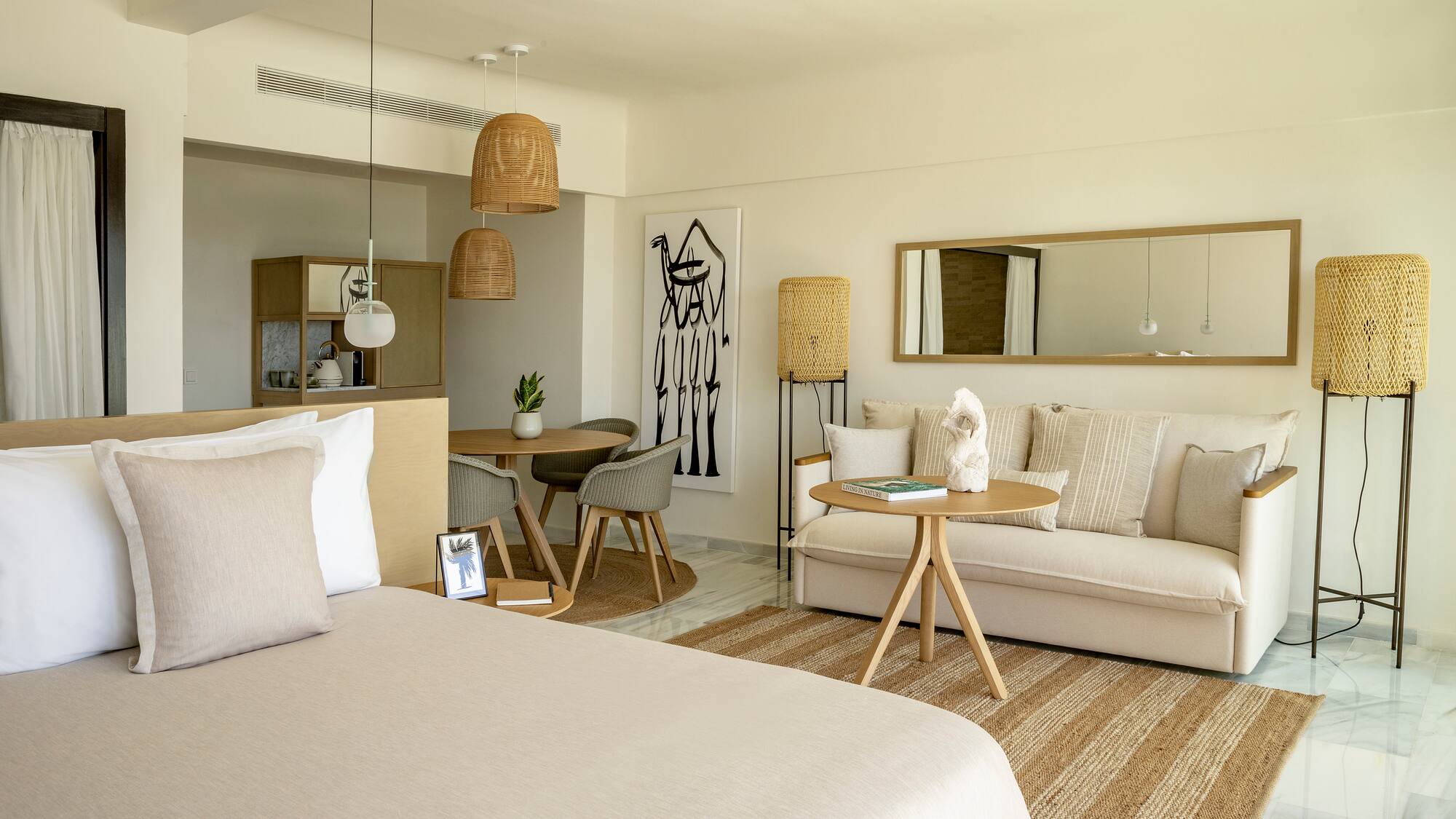 a room with a bed and a table and chairs