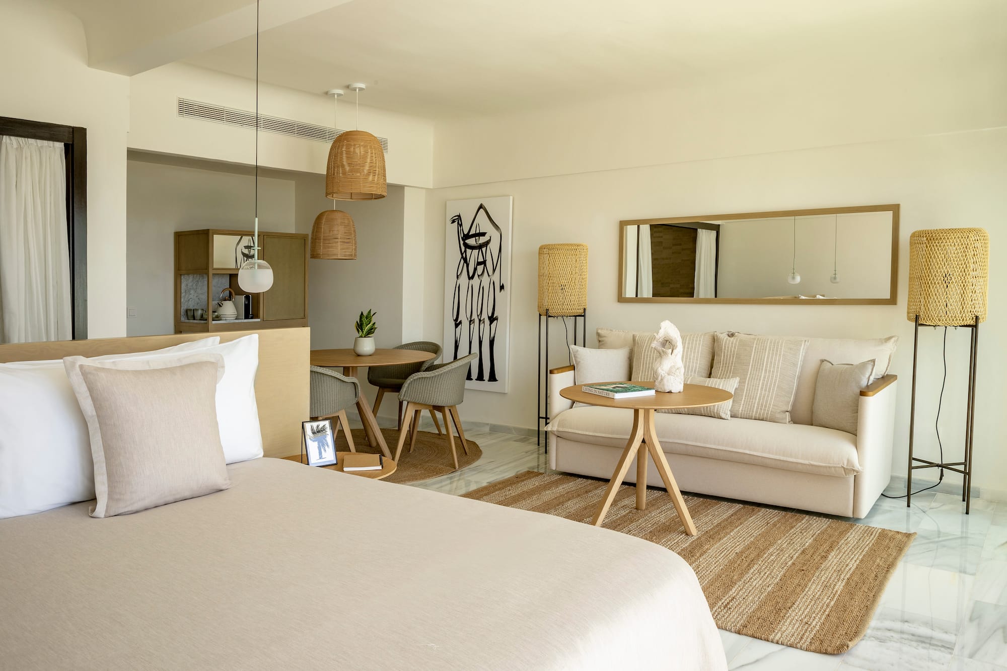 a room with a bed and a table and chairs