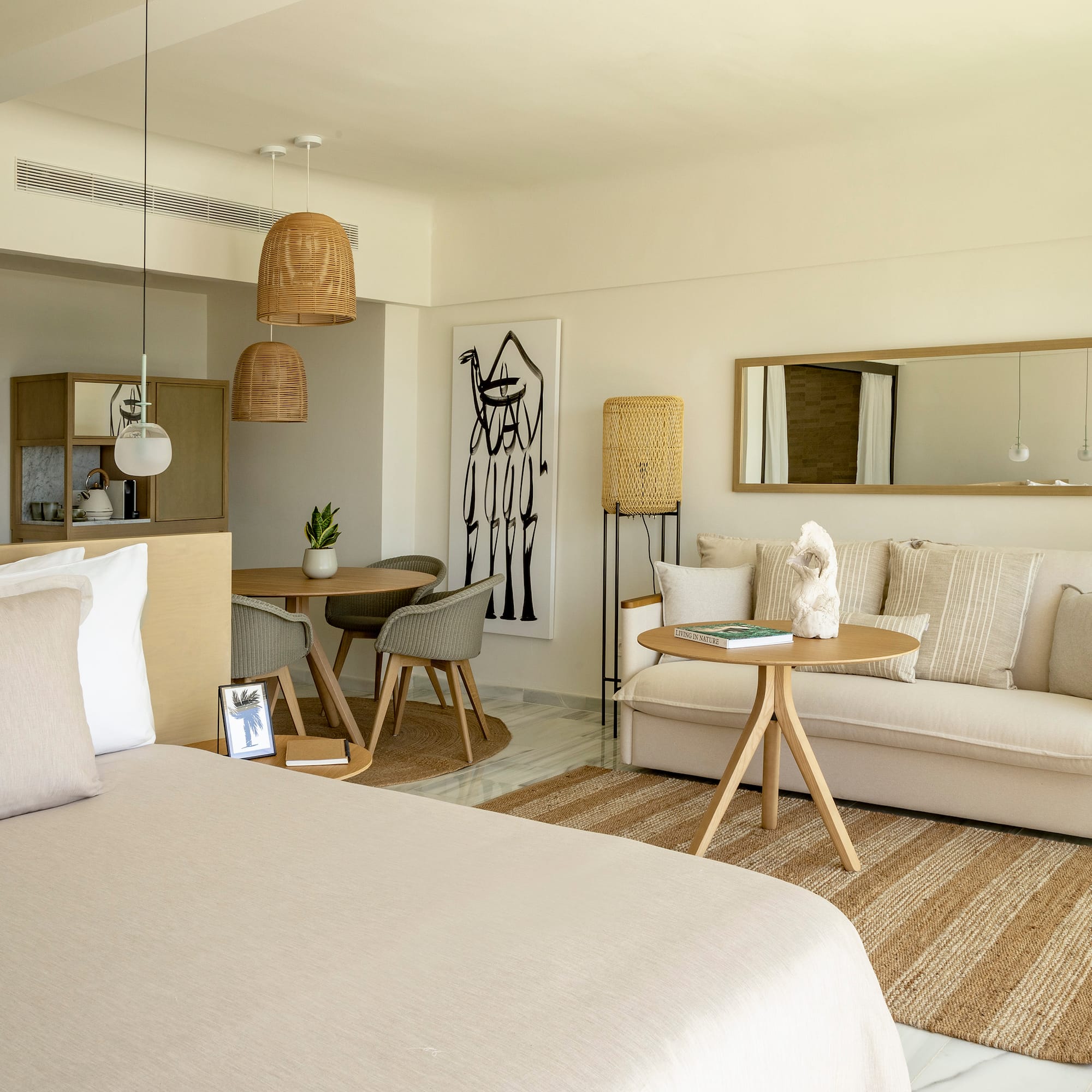 a room with a bed and a table and chairs