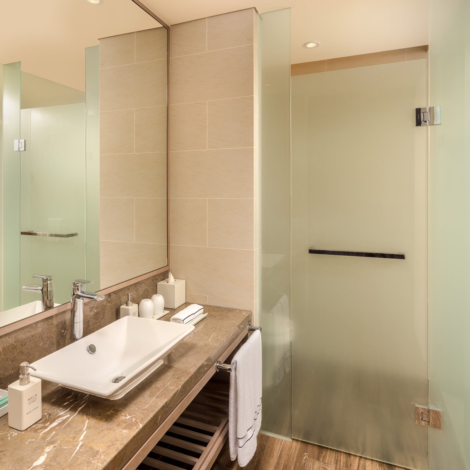 a bathroom with a sink and glass shower