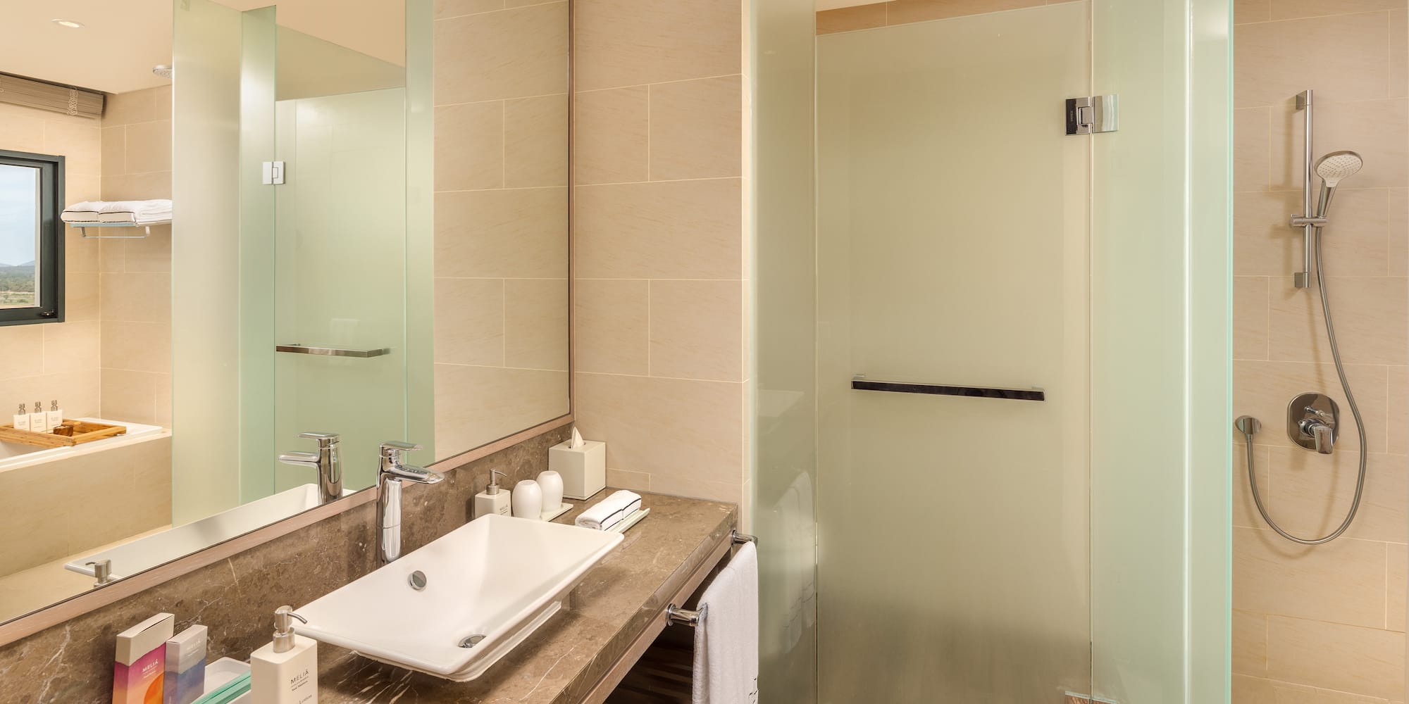 a bathroom with a sink and glass shower