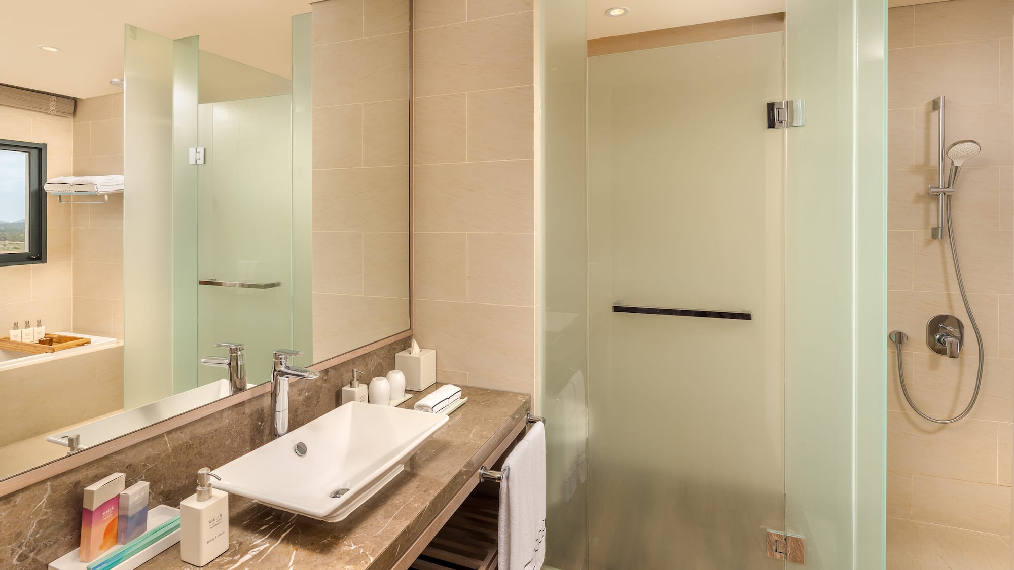 a bathroom with a sink and glass shower