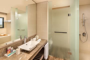 a bathroom with a sink and glass shower