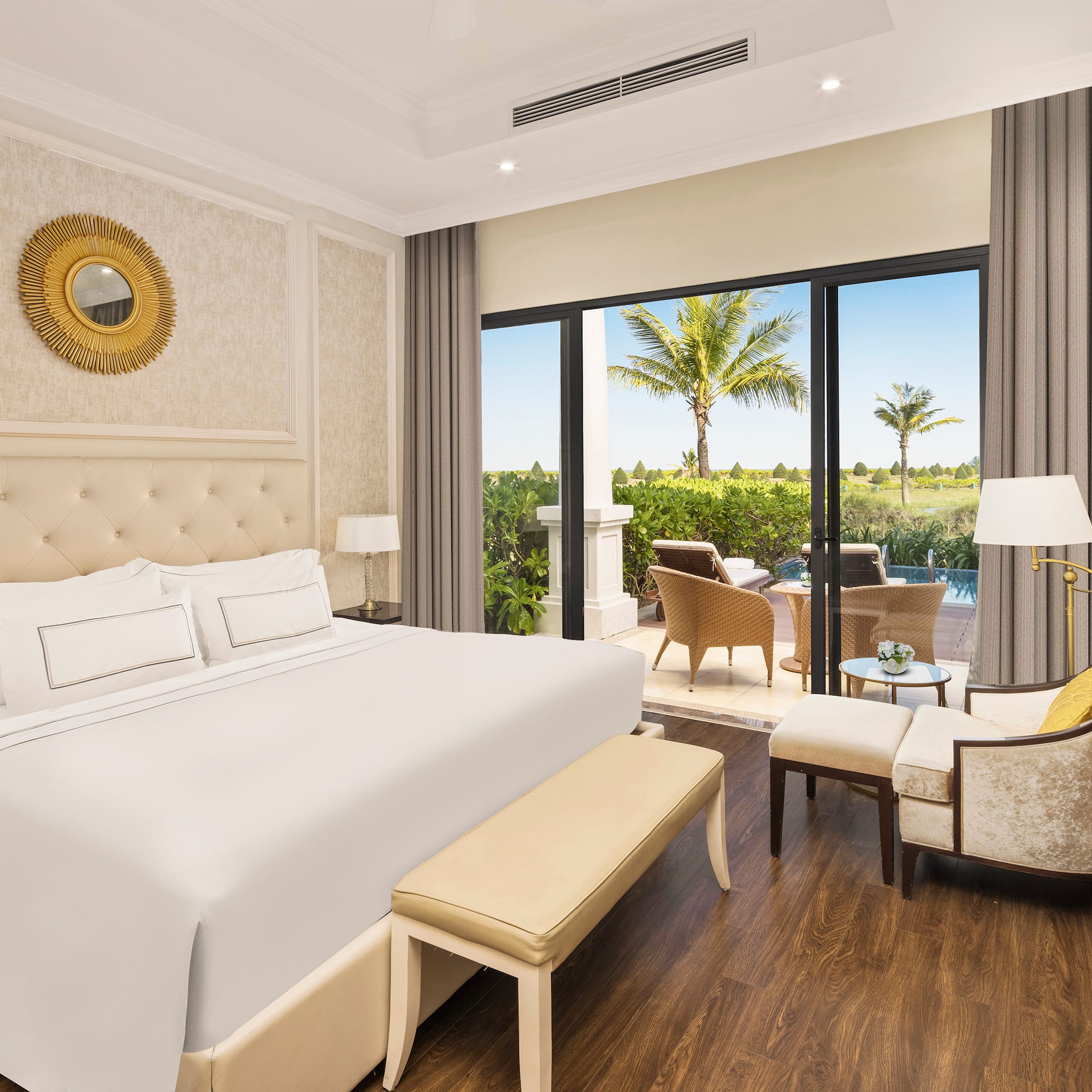 a bedroom with a bed and chairs