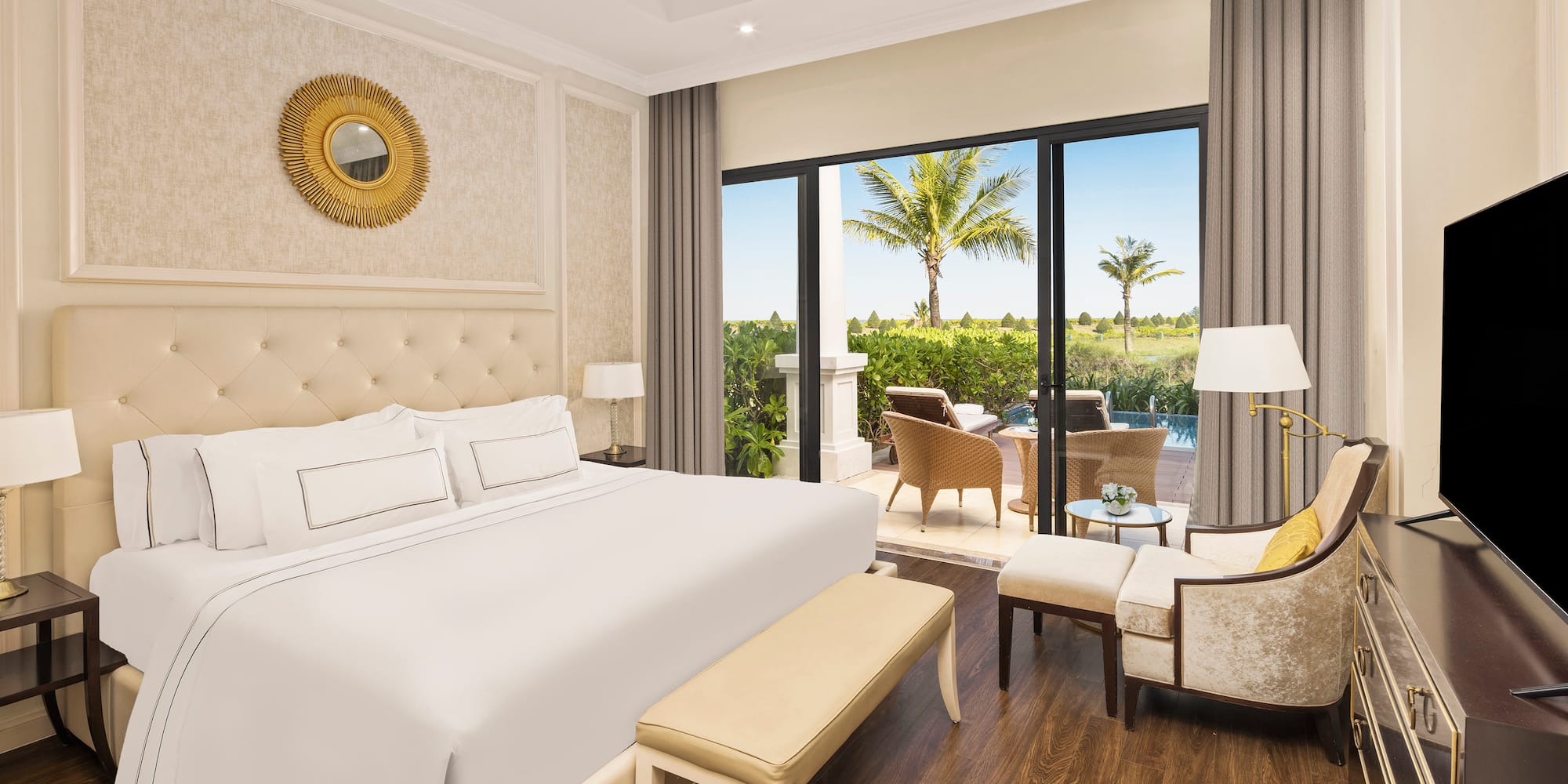 a bedroom with a bed and chairs