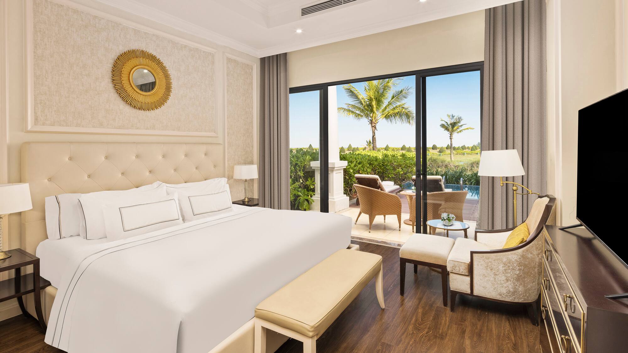 a bedroom with a bed and chairs