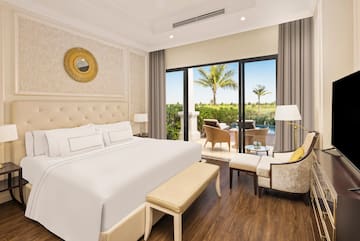 a bedroom with a bed and chairs
