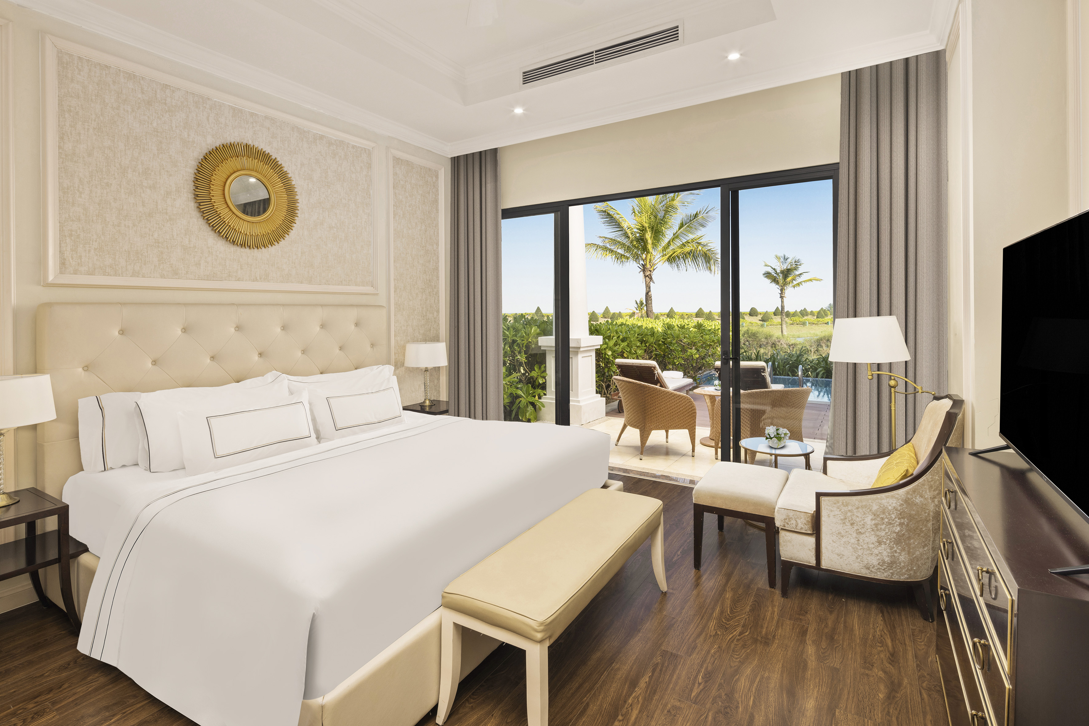 a bedroom with a bed and chairs