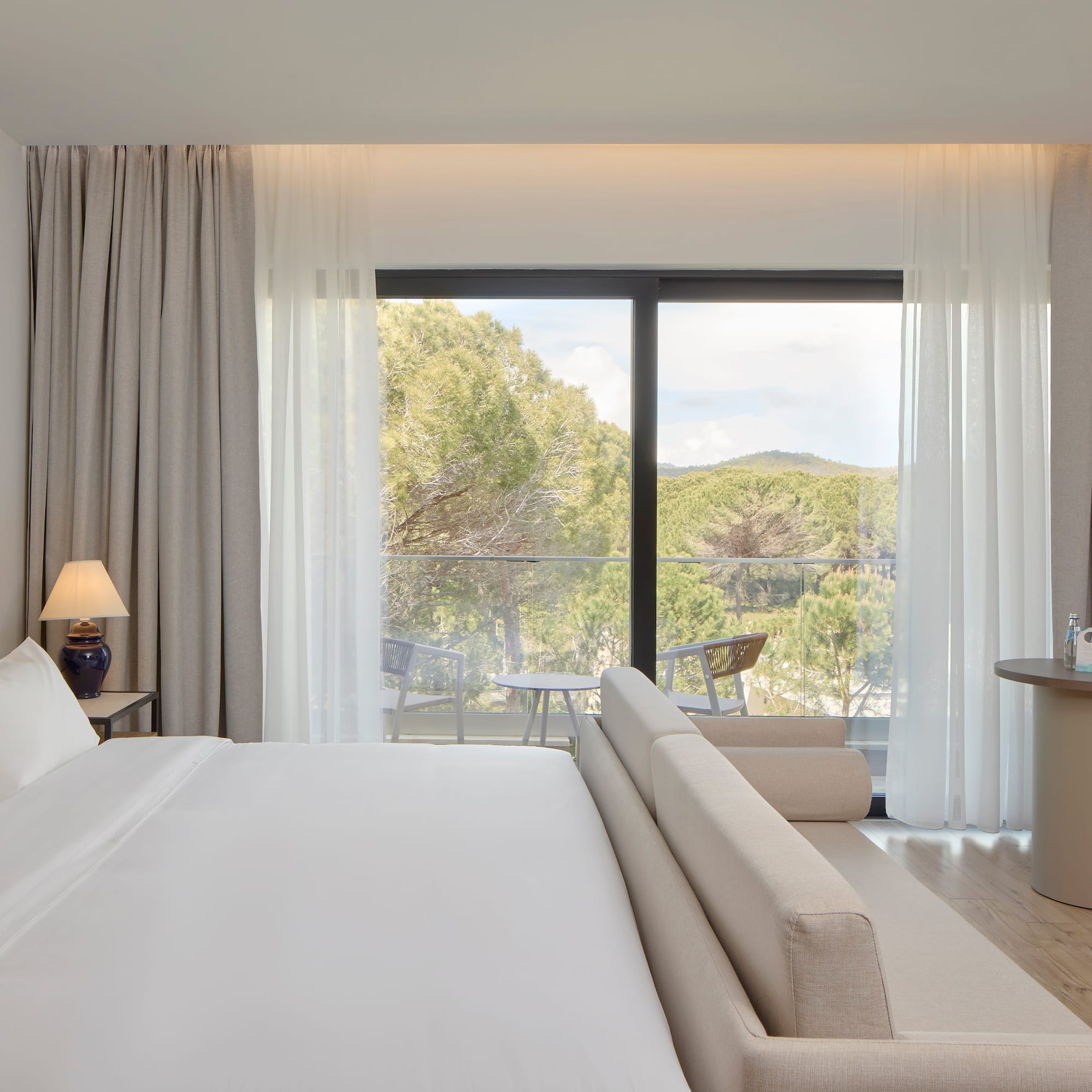 a bedroom with a bed and a table and chairs