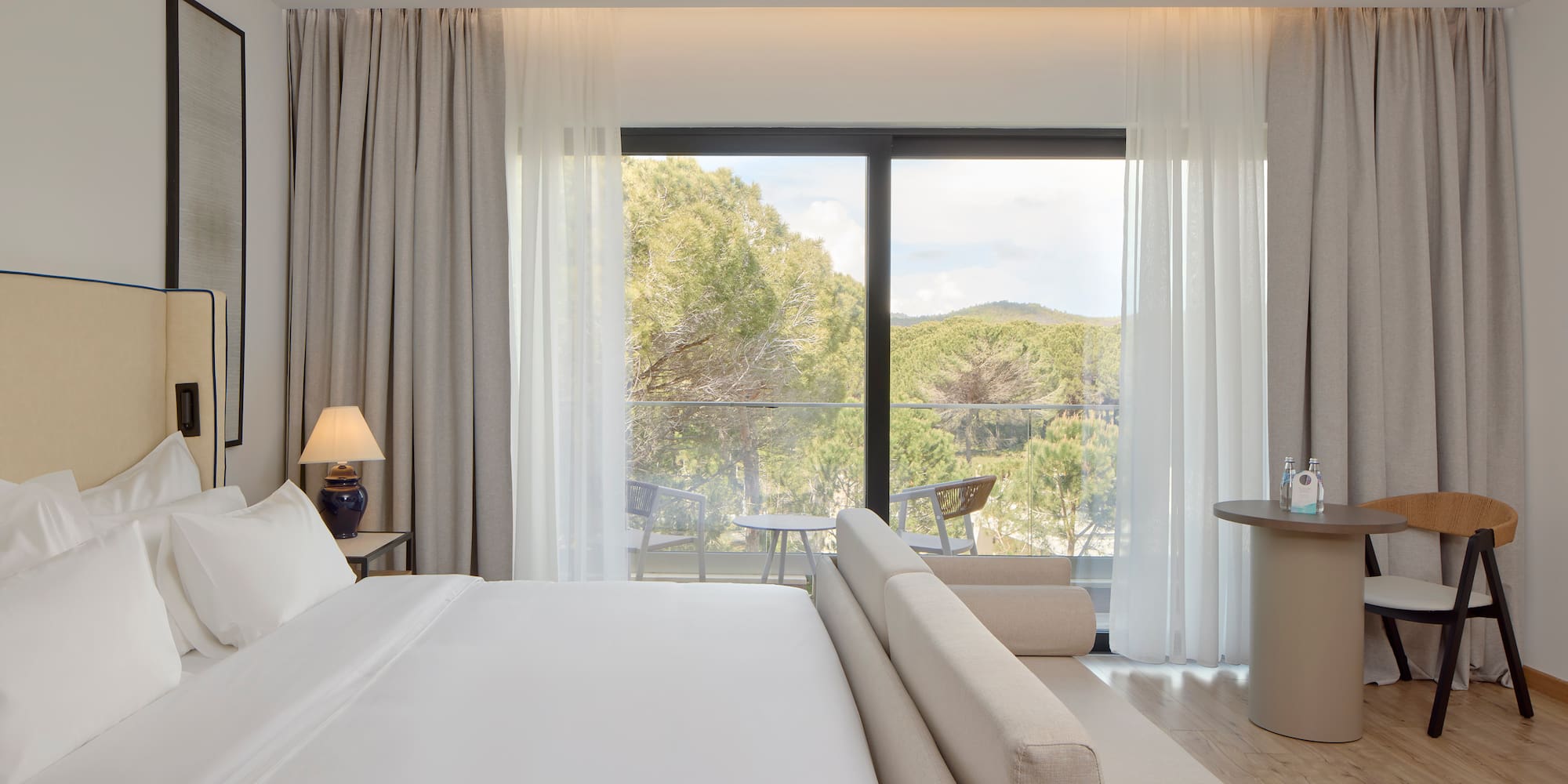 a bedroom with a bed and a table and chairs