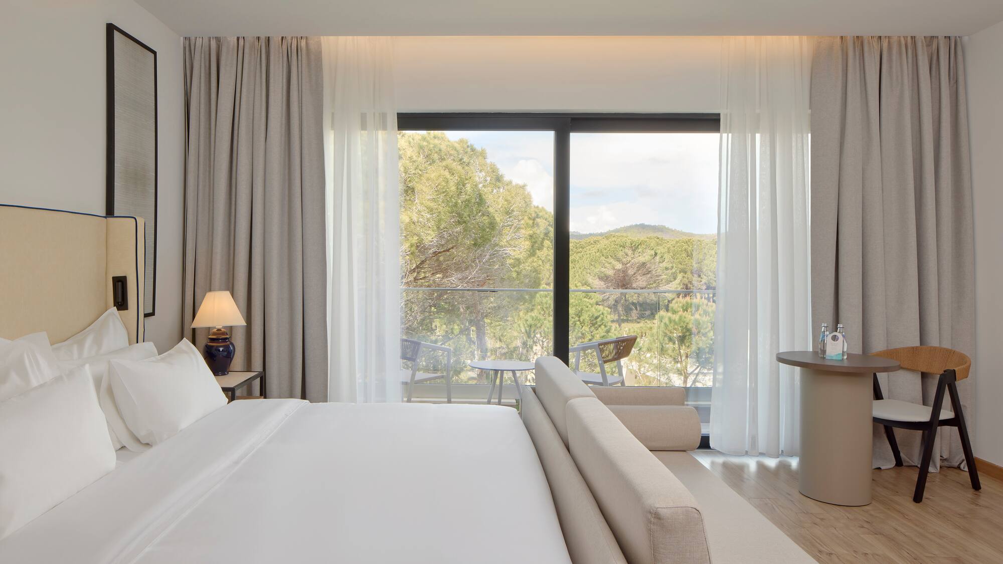 a bedroom with a bed and a table and chairs