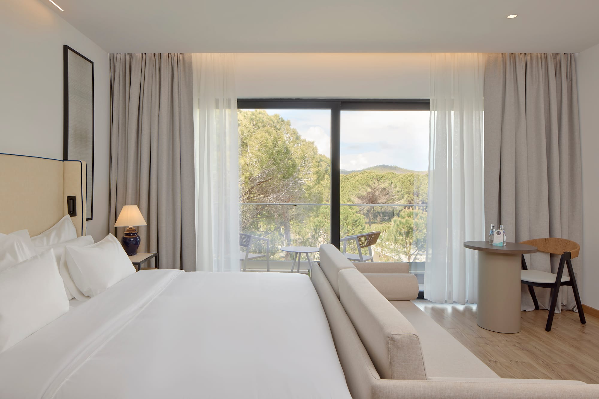 a bedroom with a bed and a table and chairs