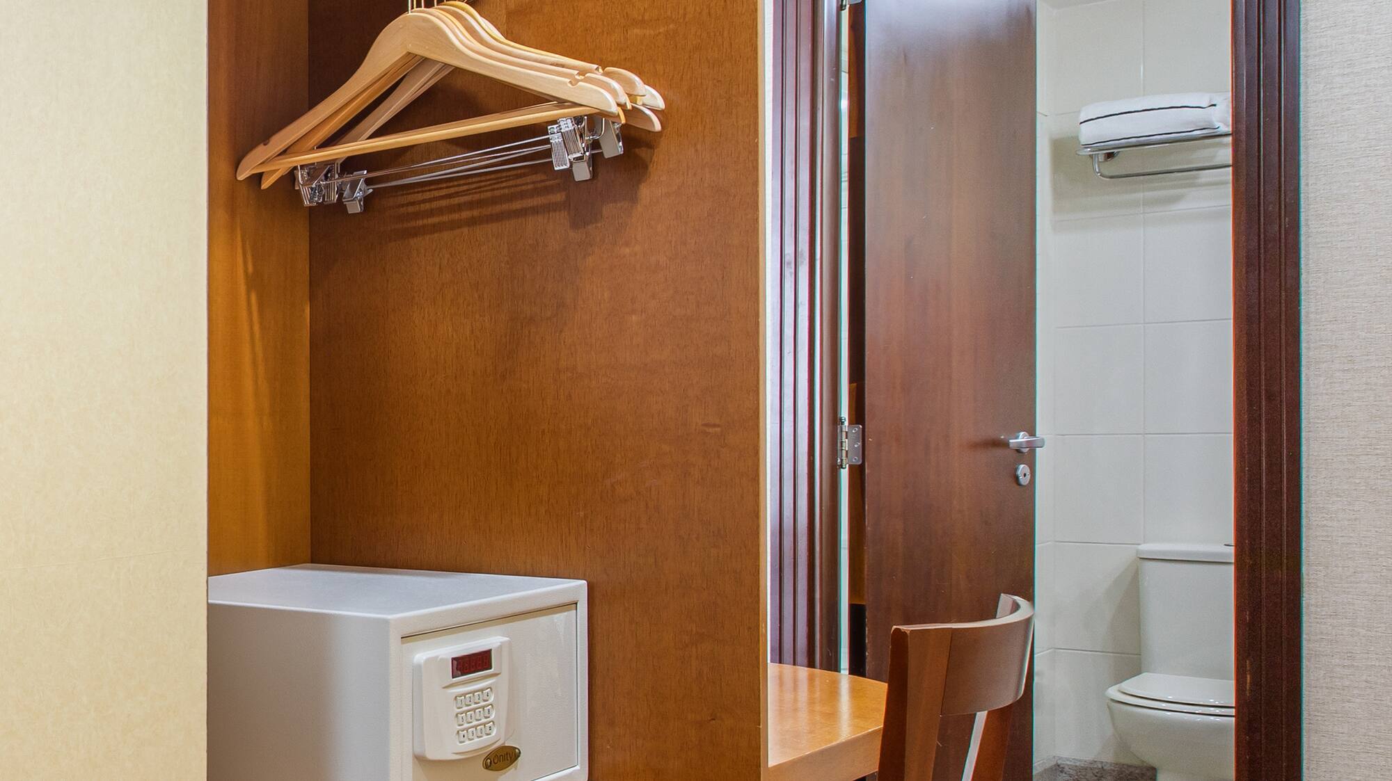 a closet with a door and a white microwave