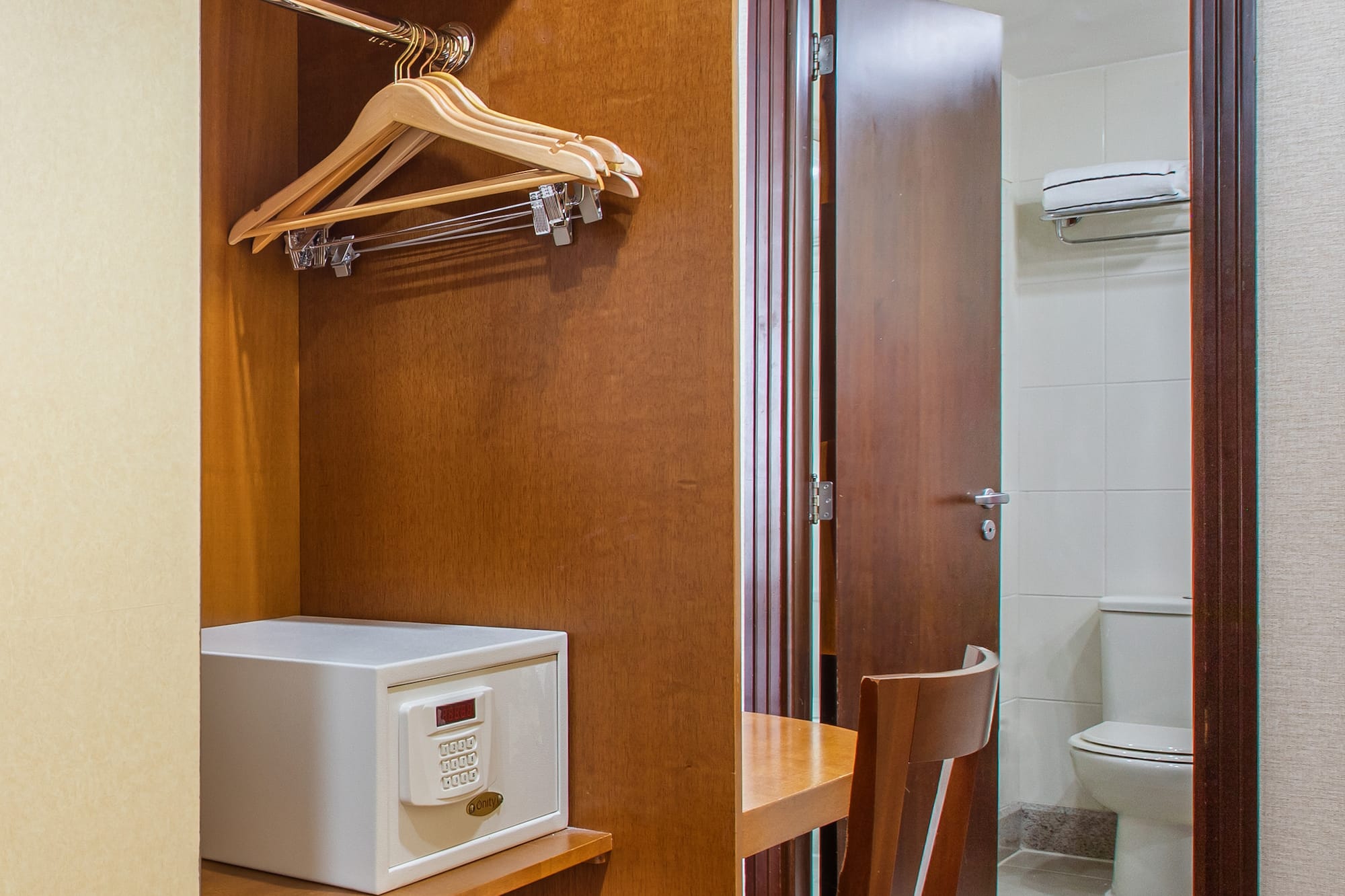 a closet with a door and a white microwave