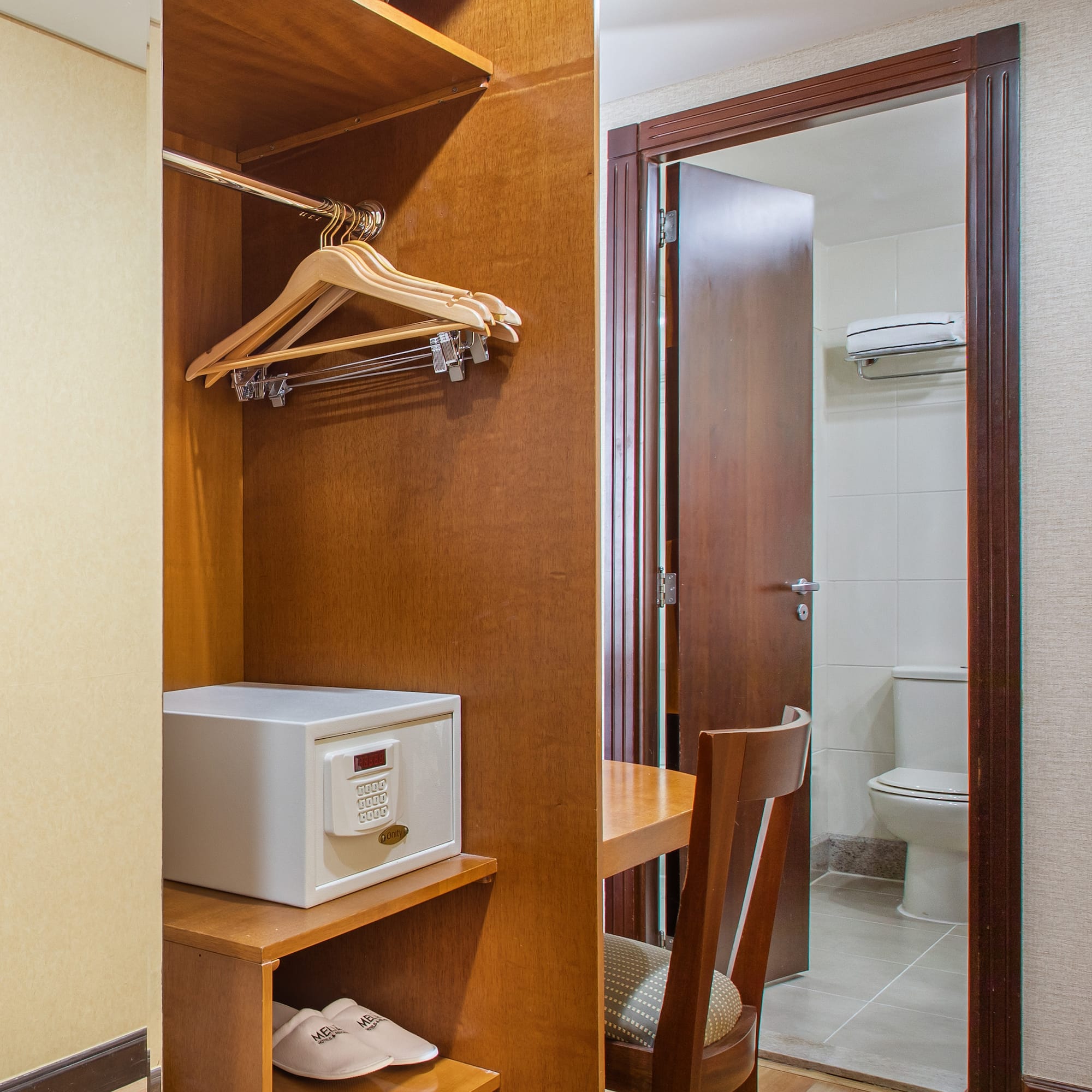 a closet with a door and a white microwave