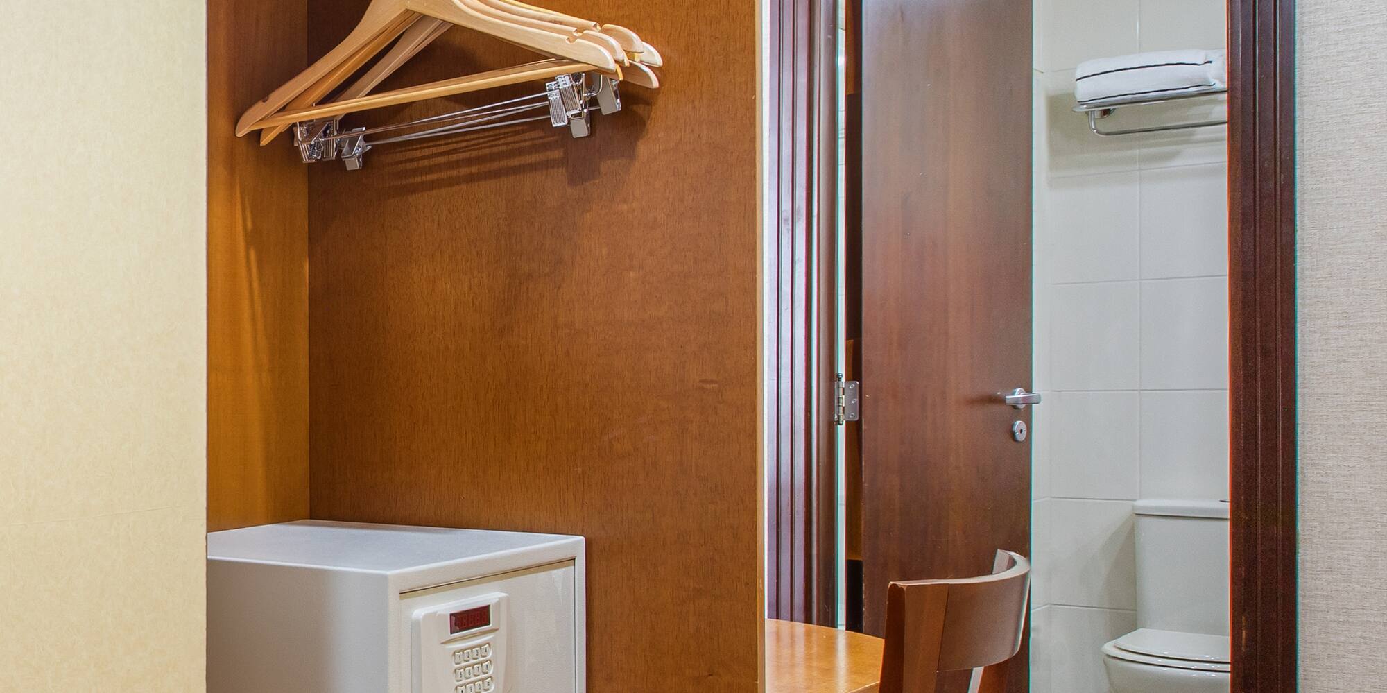 a closet with a door and a white microwave