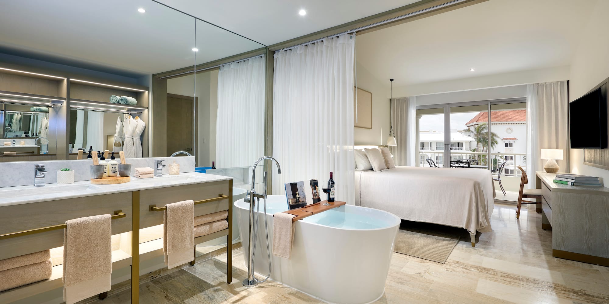 a bathroom with a tub and a bed