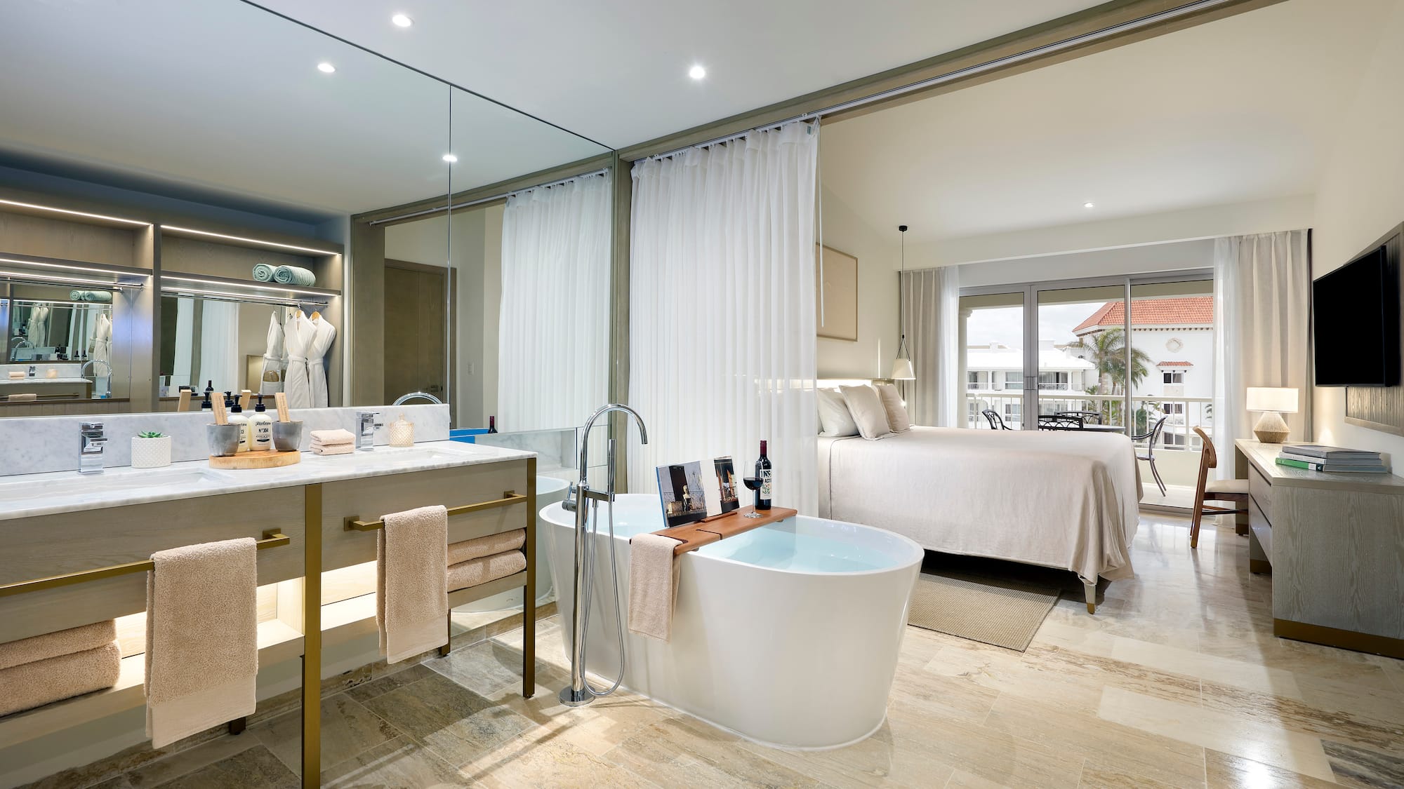 a bathroom with a tub and a bed