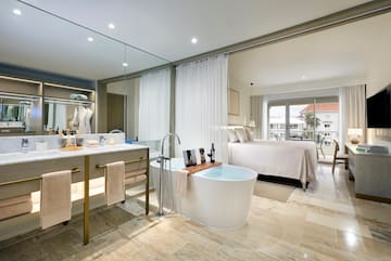 a bathroom with a tub and a bed