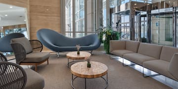 a room with a couch and chairs