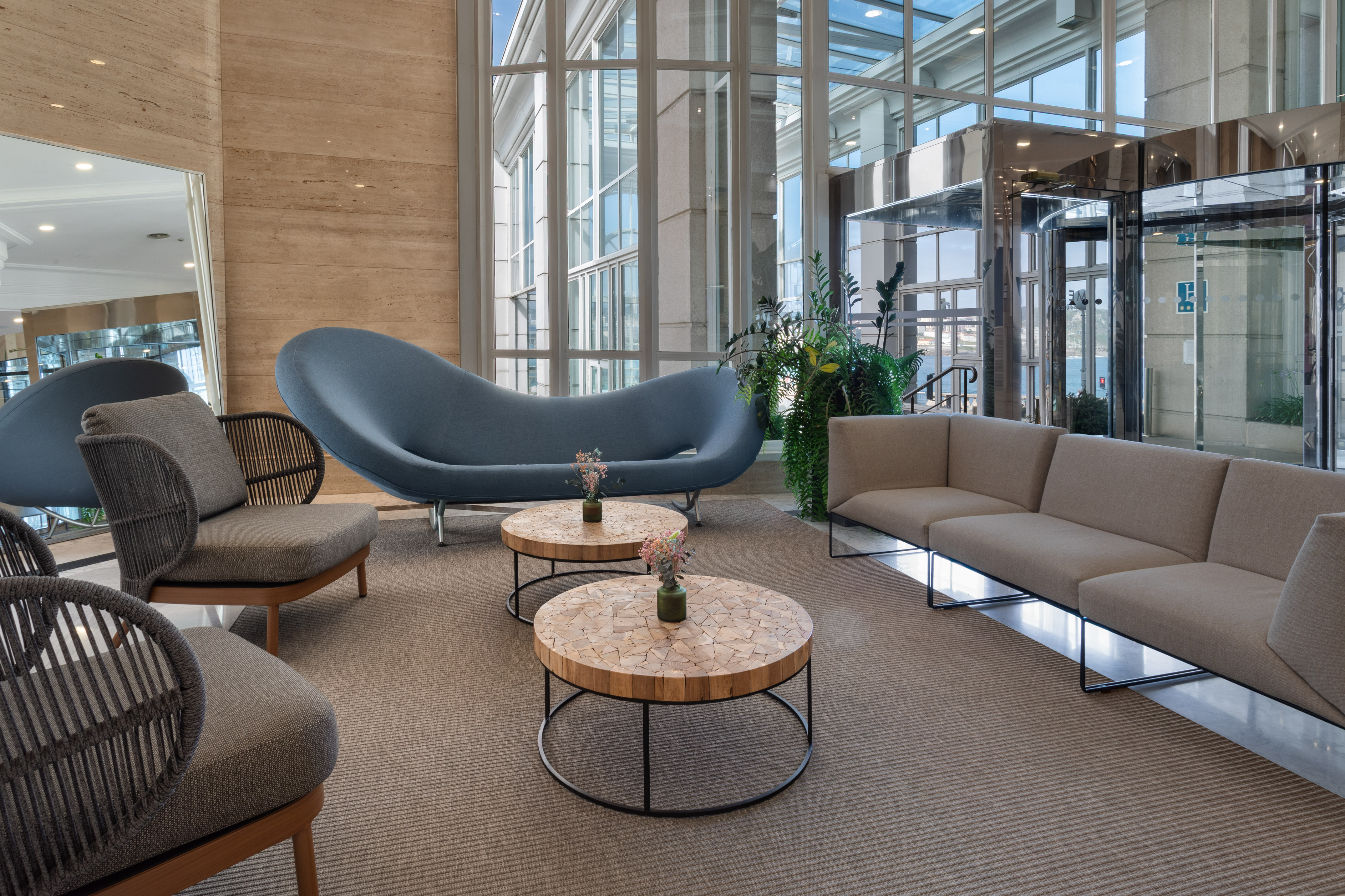 a room with a couch and chairs