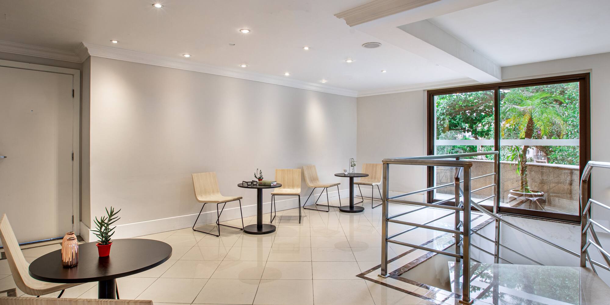 a room with a glass wall and a table and chairs