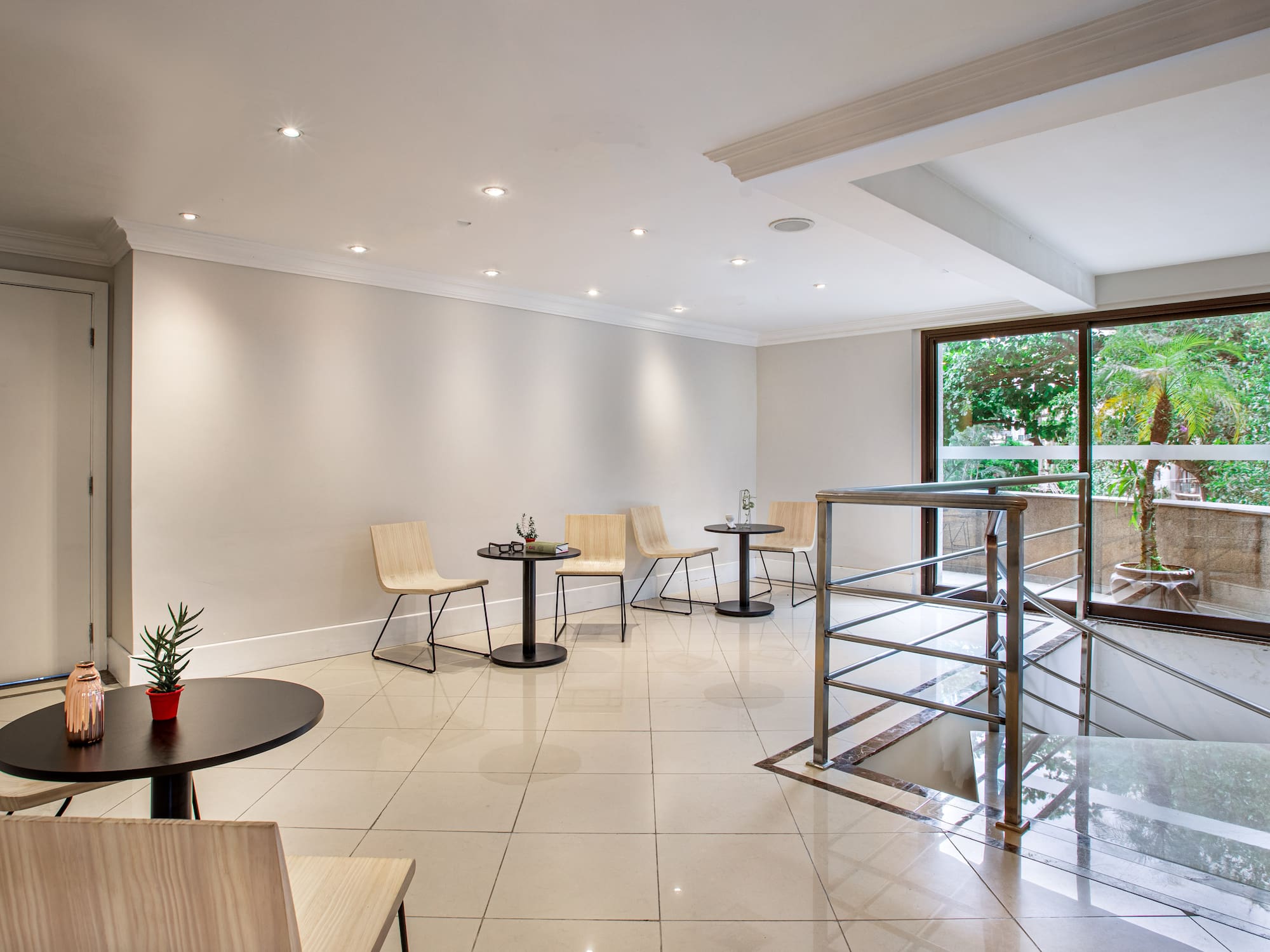 a room with a glass wall and a table and chairs