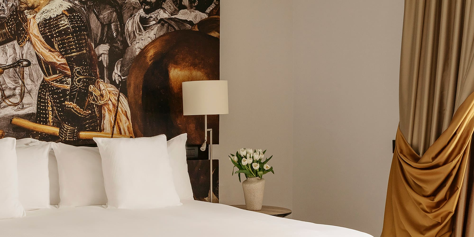 a bed with a picture of a man on the wall