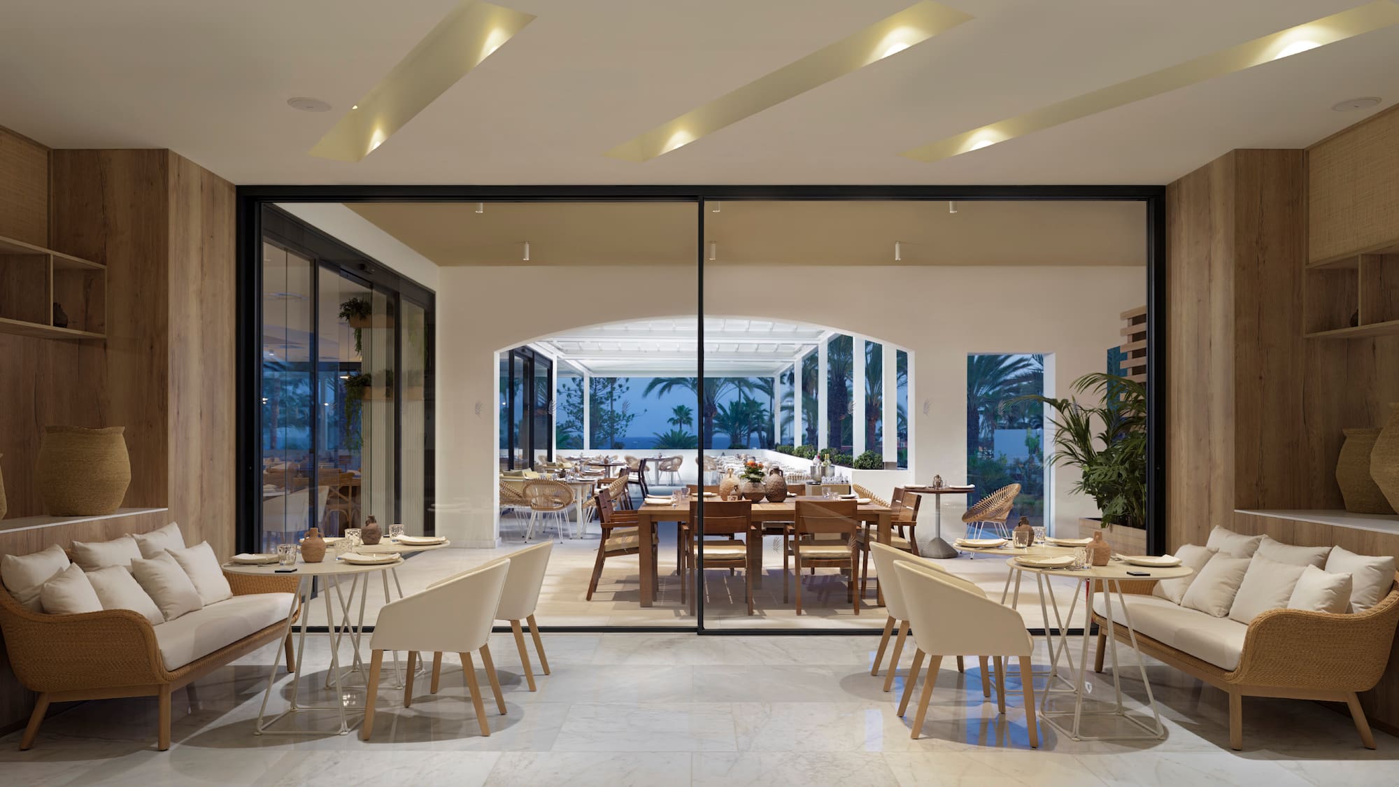 a room with a large glass wall and a table and chairs